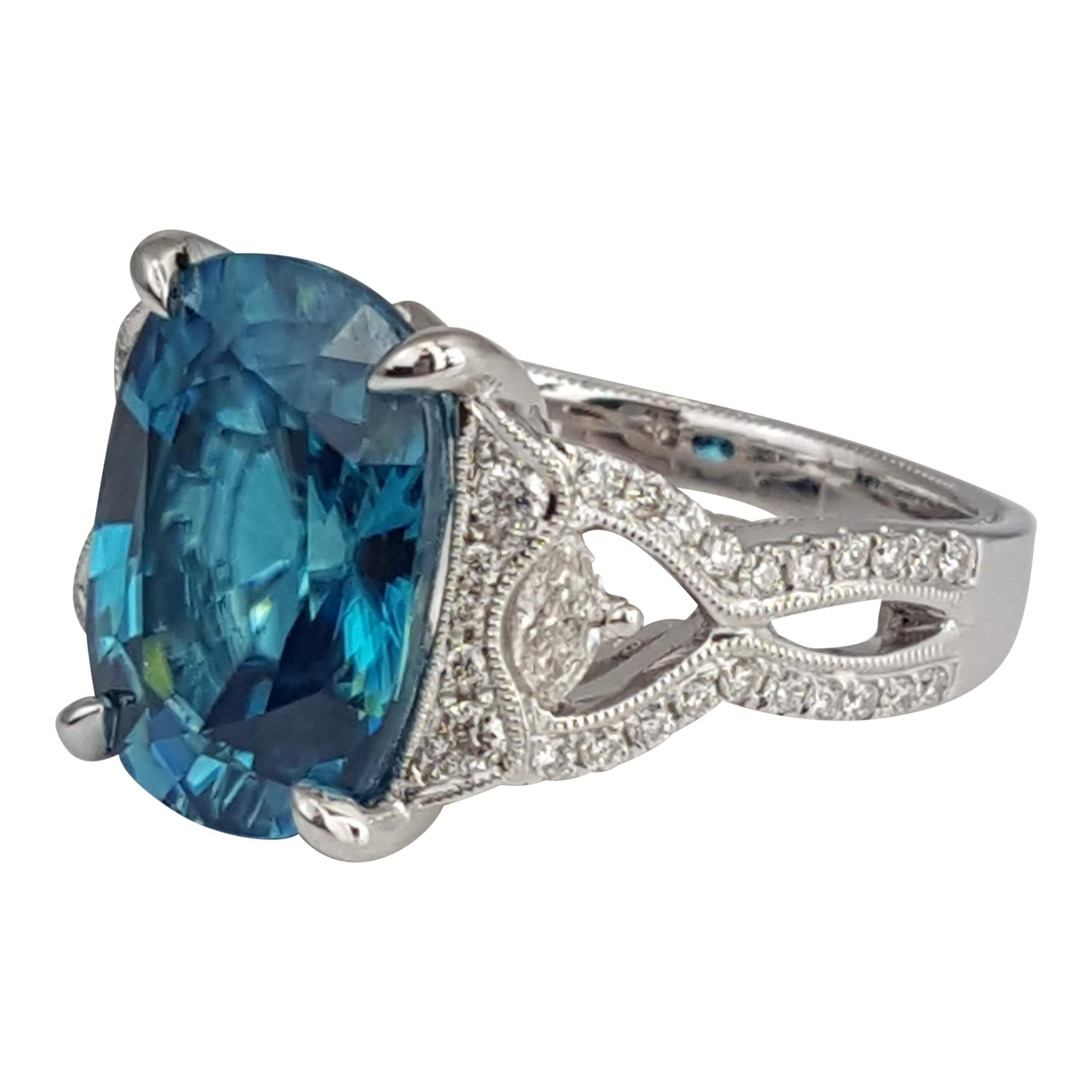 Exuding mesmerizing charm, this ring features a captivating 9.98 carat oval-cut blue zircon as its centerpiece, radiating brilliance and encircled by a stunning ensemble of 0.54 carats of natural diamonds. The meticulous craftsmanship is evident in