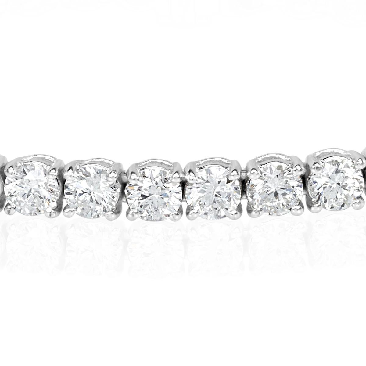 This gorgeous diamond tennis bracelet showcases 9.98ct of impeccably matched round brilliant cut diamonds graded at F-G in color, SI1-SI2 in clarity. They are set in a classic handmade, 18k white gold setting that appears to float on the wrist.
