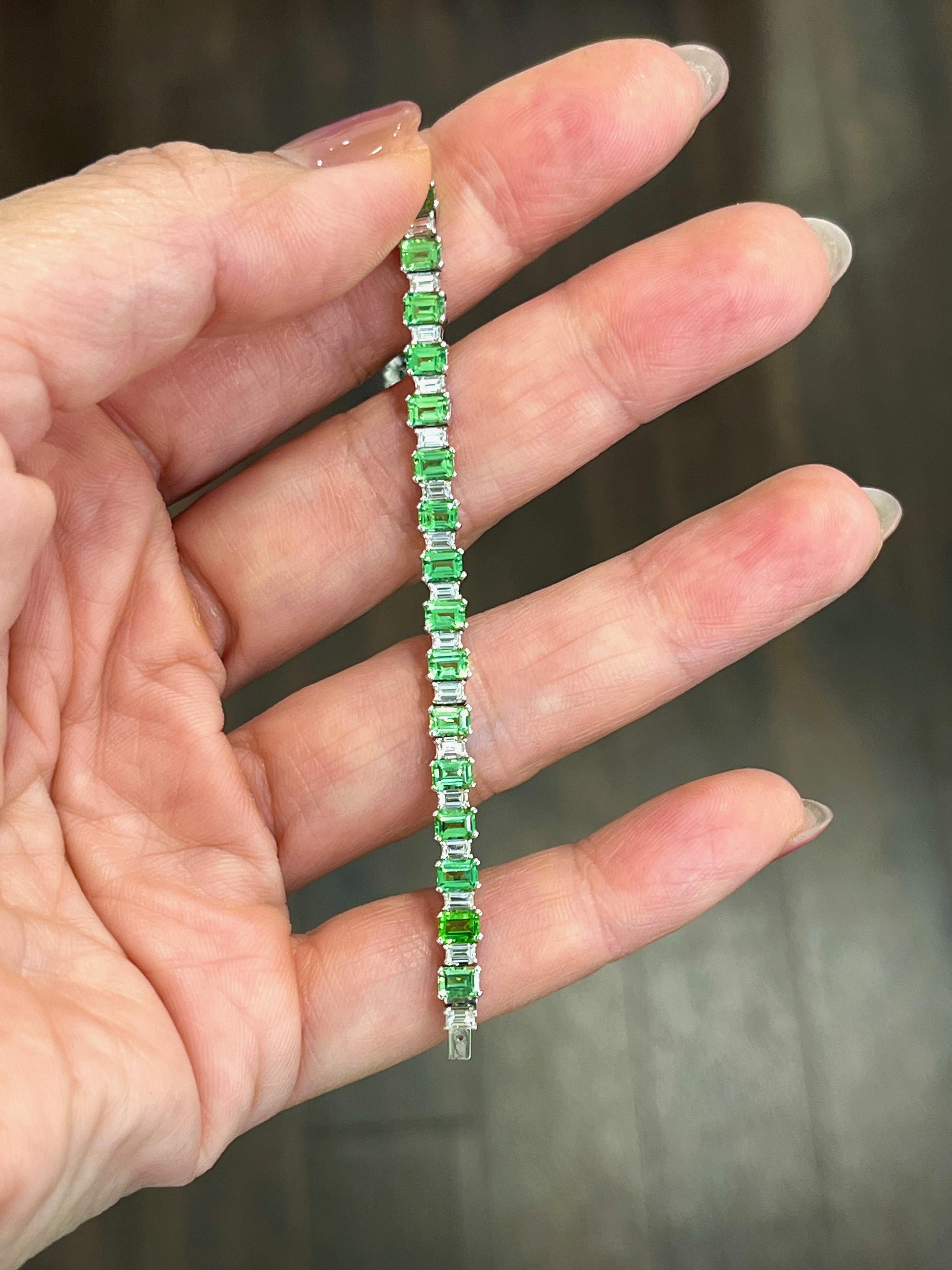 This gorgeous natural green garnet and diamond ring weighs 9.99 ct. This ring features 35 garnets at 8.19 ct and 35 diamonds at 1.80 ct. The diamonds are E/F in color and VS1/VS2 in clarity. 