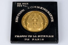 999 thousandths gold coin bearing the effigy of Tutanchamon and Regina Nofretete