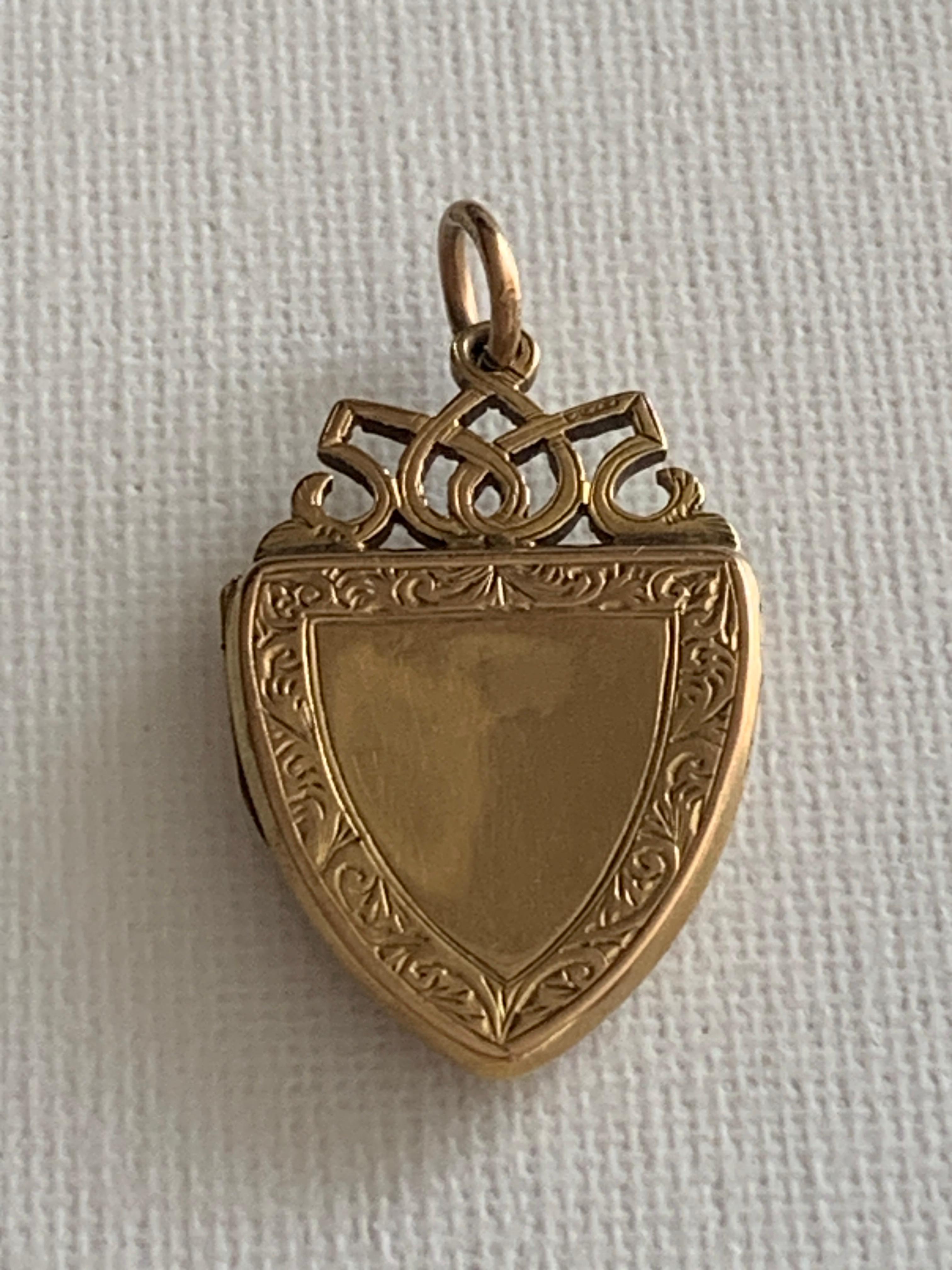 Antique
9ct 375 Gold Shield Shaped Locket
with a beautiful angular en-scrolled top
Full British Hallmarks
Dated 1921 Birmingham date Letter W.
Goldsmiths 