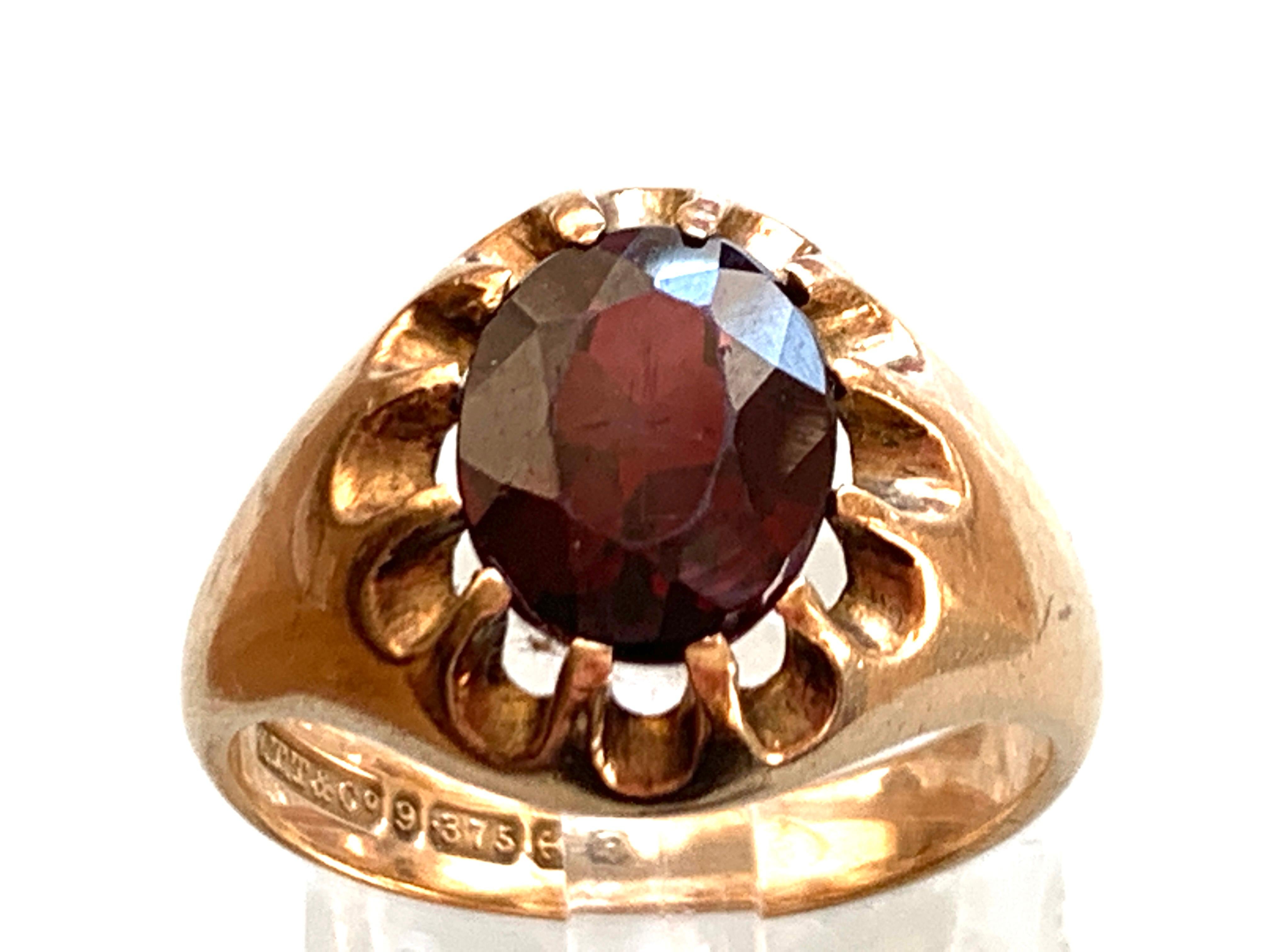9ct 375 Gold  Vintage Wine Red Gemstone Ring 
Unknown Gemstone Size 9mm x 7mm 
Era 1950
Full British Hallmarks W.T.T & C0. dated 1956
W T Toghill & Co - Birmingham
U.K Size S = 19.1 mm inner diameter 
U.S  Size 9 1/8 
Total Weight 5.7 grammes 