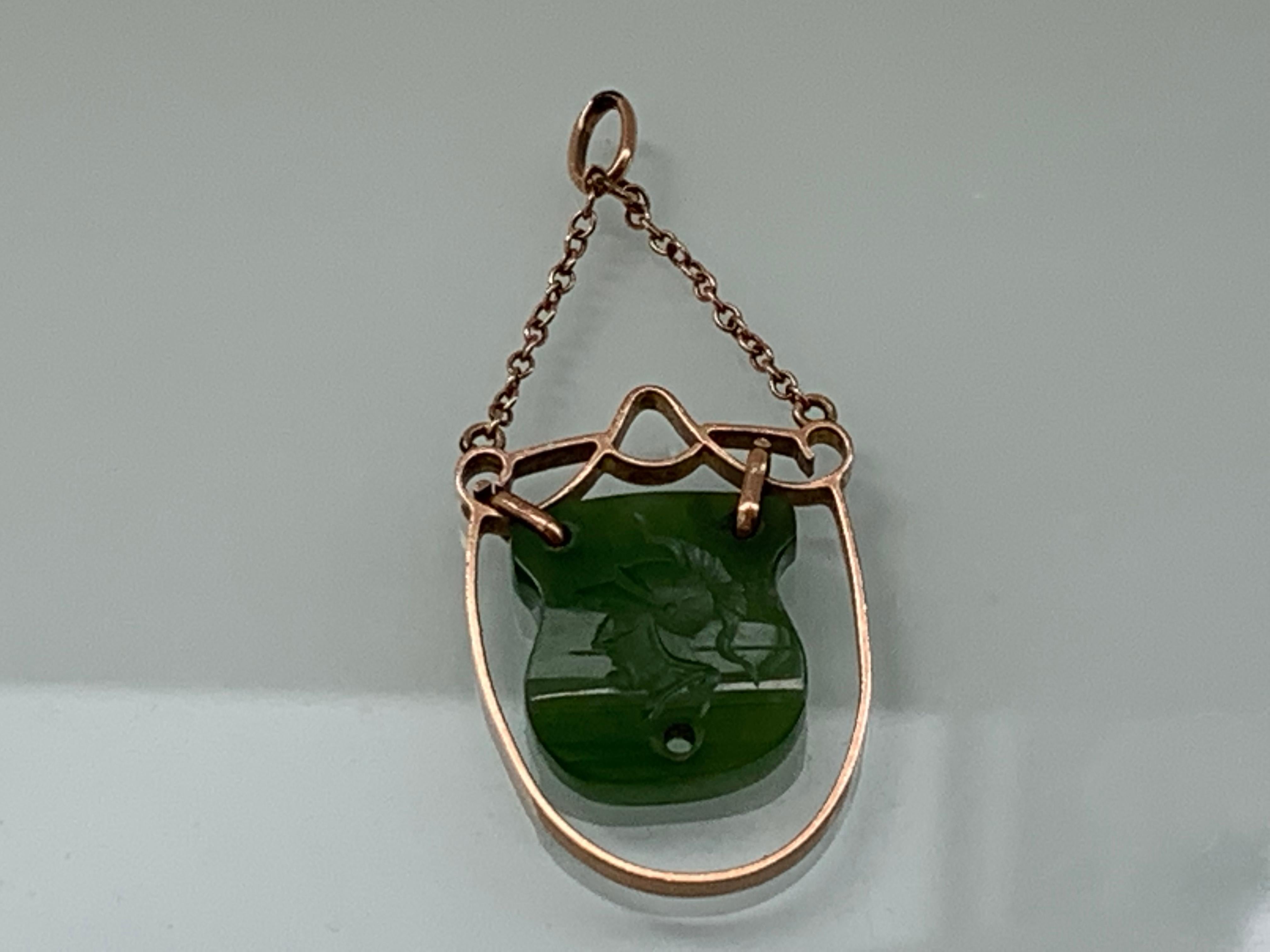 9ct Gold Antique Jade Stone intaglio Pendant
Hand carved centurion Bust
Stamped 9ct on the side 
Hint of Rose Gold in colour.
There is a hole in the base of the jade - which does seem 
something is missing .