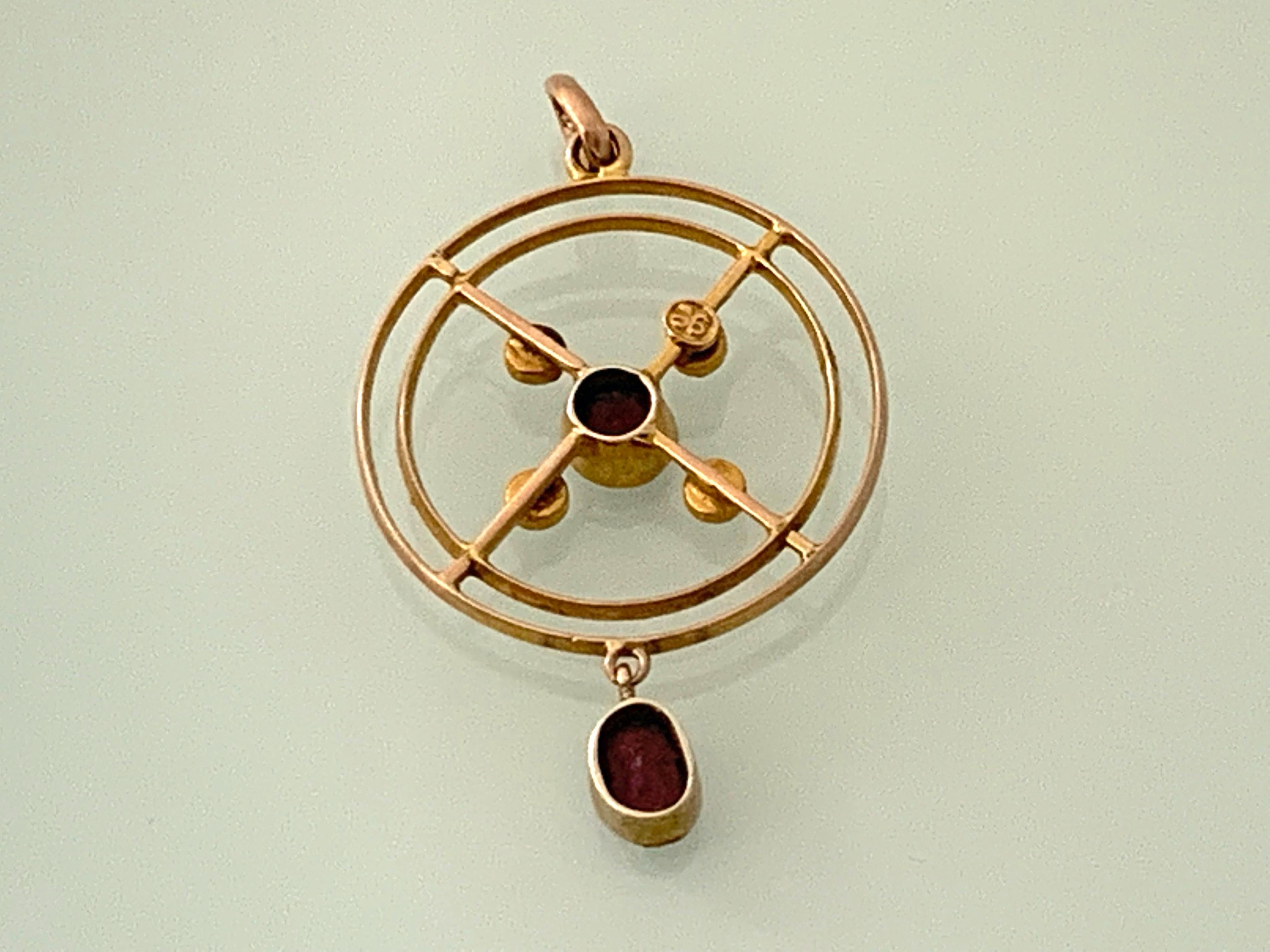 9ct Gold Art Deco Pendant
Geometric Design - displaying perfect symmetry
Two Faceted cut garnets adorn this design 
on eis oval and one is round 
the central one surrounded by four seed pearls 
Pendant has a closed bail 
and is stamped 9ct on