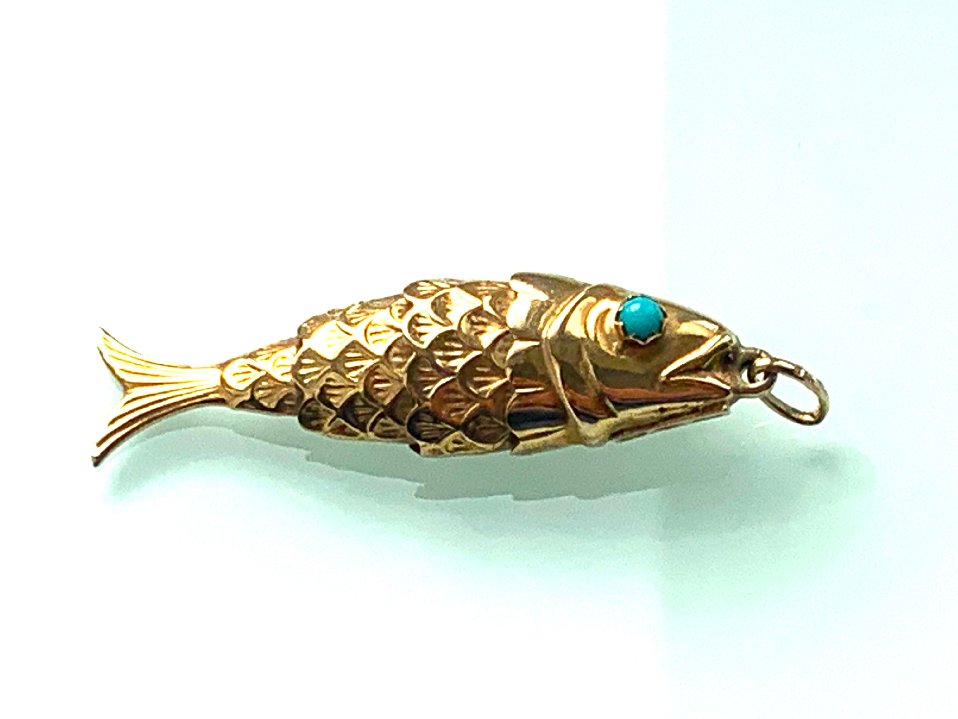 9ct 375 Gold Articulated Fish 
with a Natural turquoise stone eyes - both secure 
By Italian Goldsmith Unoaerre 
Era 1970s
Full Italian Stamps underneath and 375 1 AR & Unoaerre
and British hallmarks on the jump ring 
Size 45mm x 7mm x 3.5mm ( Incl.