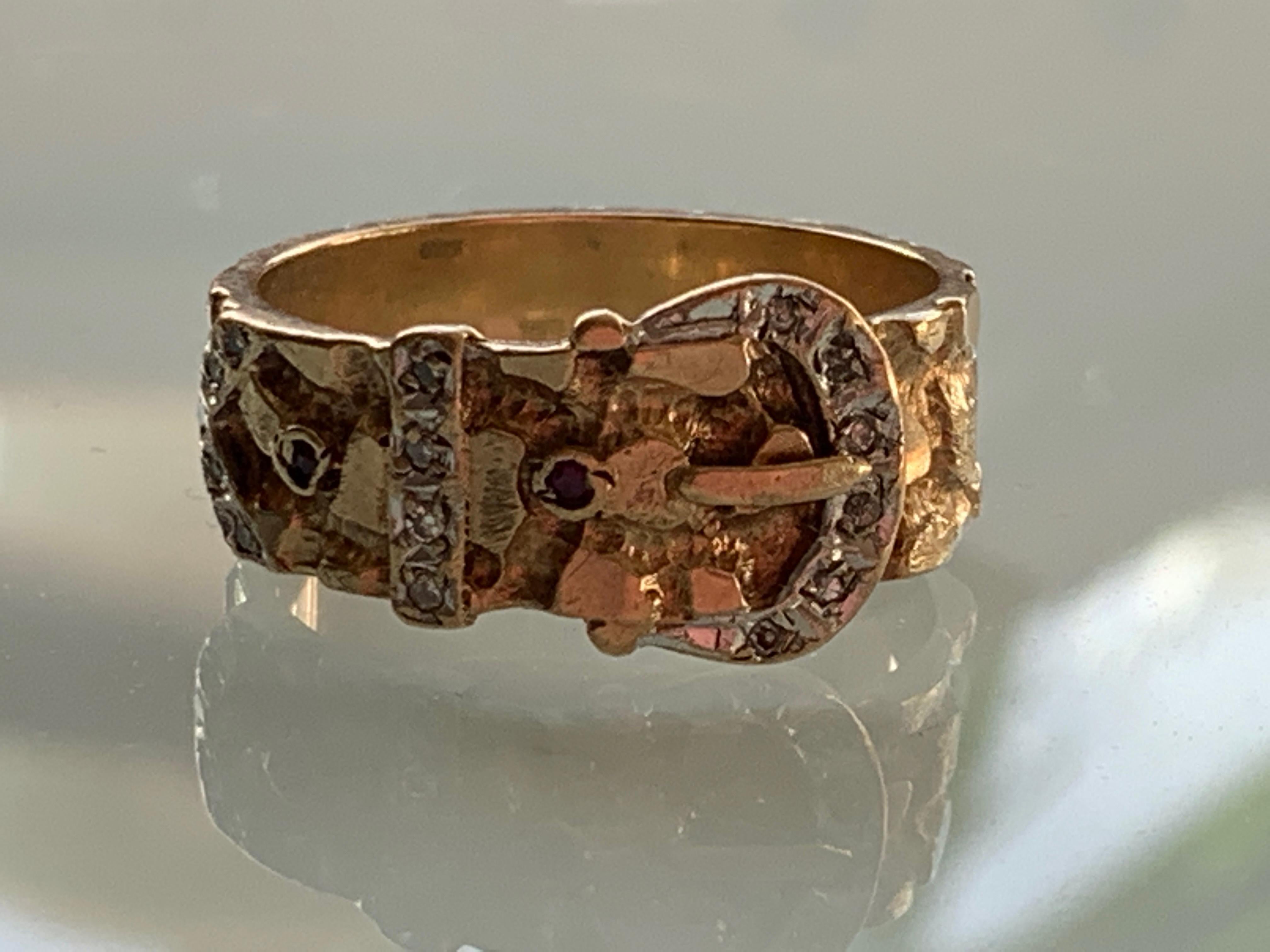 9ct Gold 1960s Buckle Ring
Bark surface design 
set with 15 x 0.8mm Natural diamonds
and 2 x 0.8mm Natural Rubies

Size
U.K Size U
U.S Size 10/4

Thickness - 7.8mm
Depth 1.2mm
inner diametre 20mm
inner circumference 62.2mm
