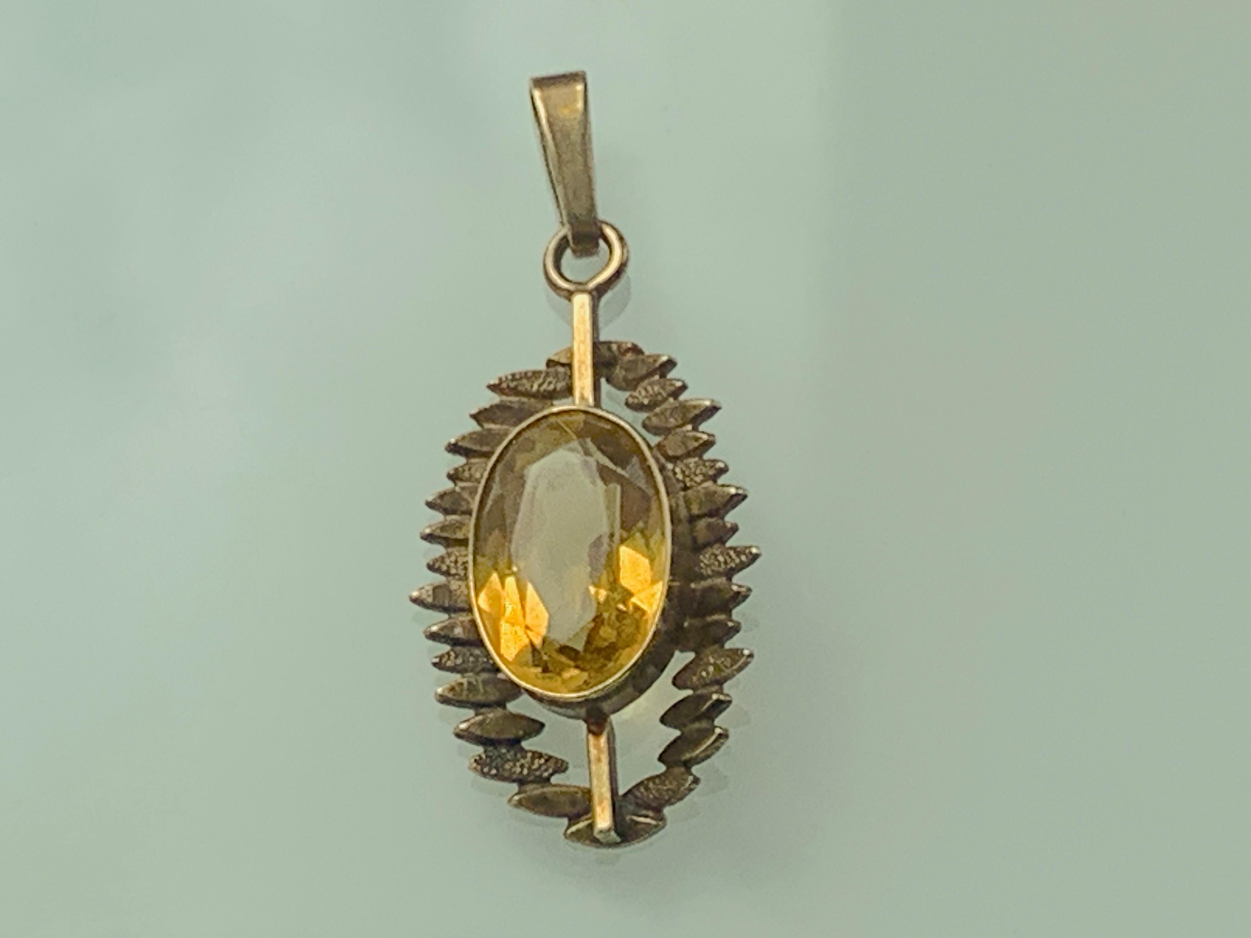 9ct Gold Design Pendant
that is quite feminine 
with central oval citrine
The Citrine is oval faceted cut & the stones size is approx 12 x 8 x 4 mm
It is fully hallmarked as aLondon import in 1968
The makers initials are W & R (unknown)
size of