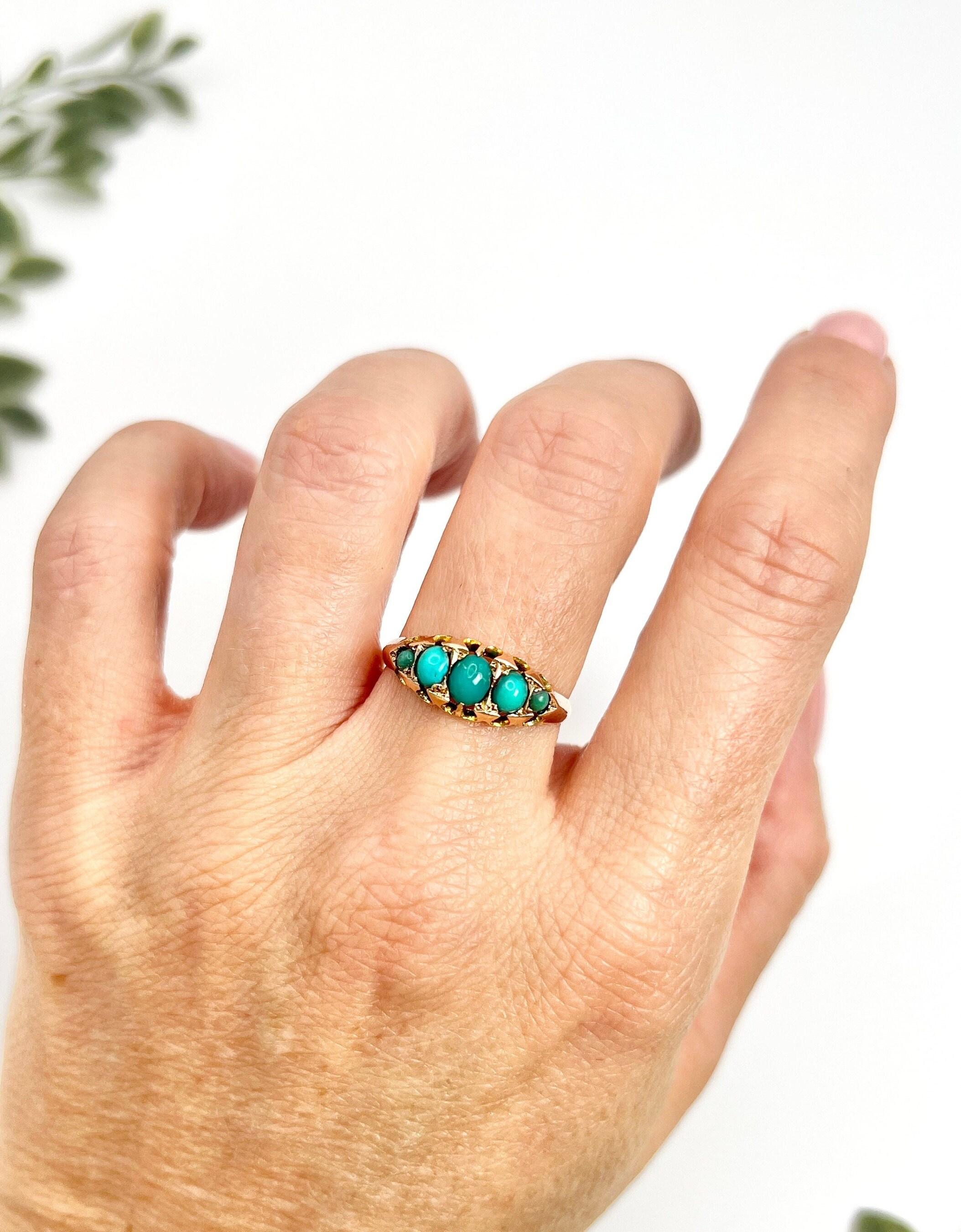 Antique Band Ring 

9ct Rose Gold Stamped 

Hallmarked Birmingham 1907

Makers Mark W C & Co

This exquisite 9ct rose gold Edwardian Band ring features a striking five-stone design set with vibrant blue turquoise stones. The stones are elegantly