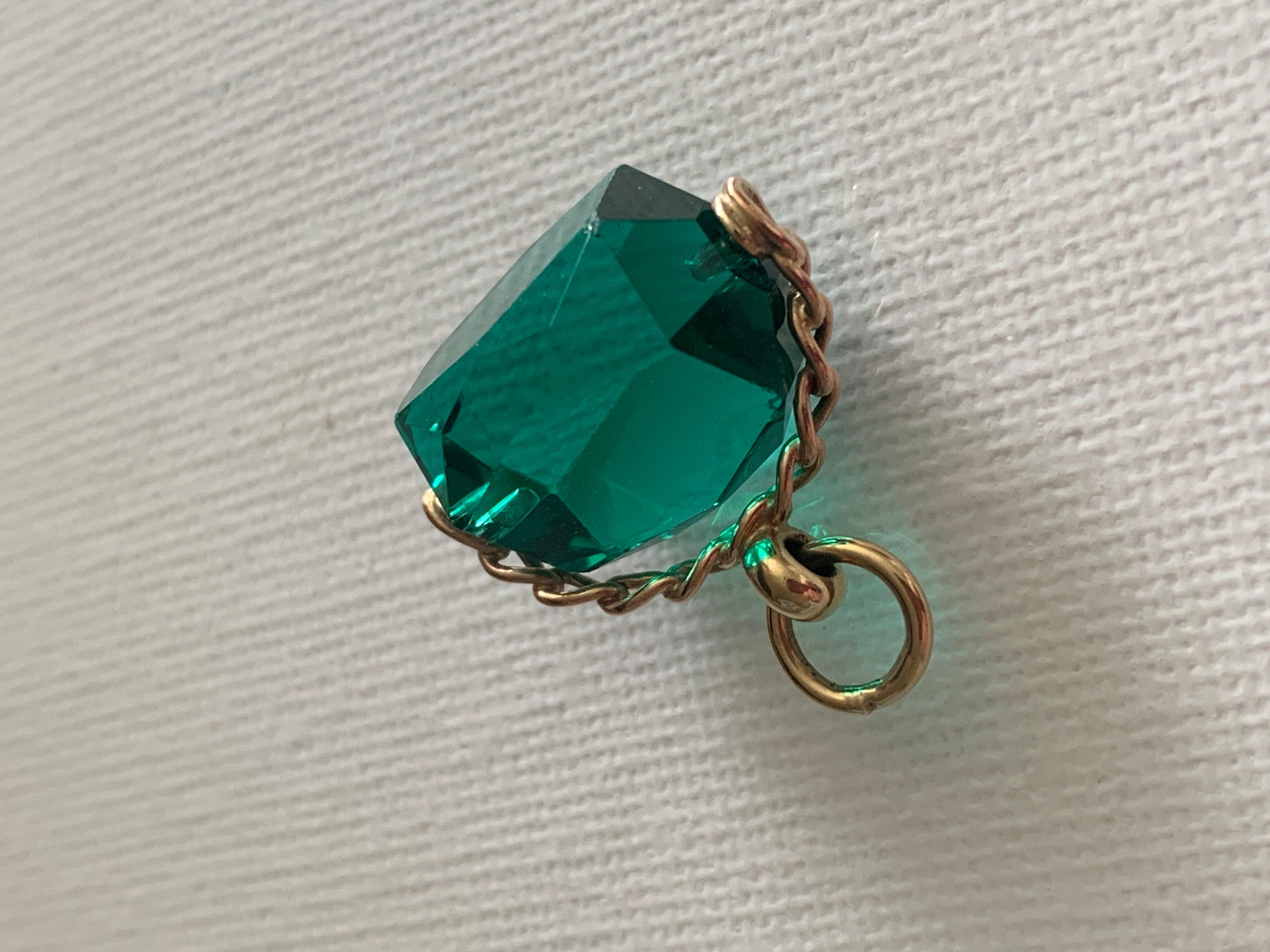 9ct Gold Emerald Green Glass Spinner Charm / Pendant 
Full British Hallmarks present 
9 375 Birmingham anchor date Letter 