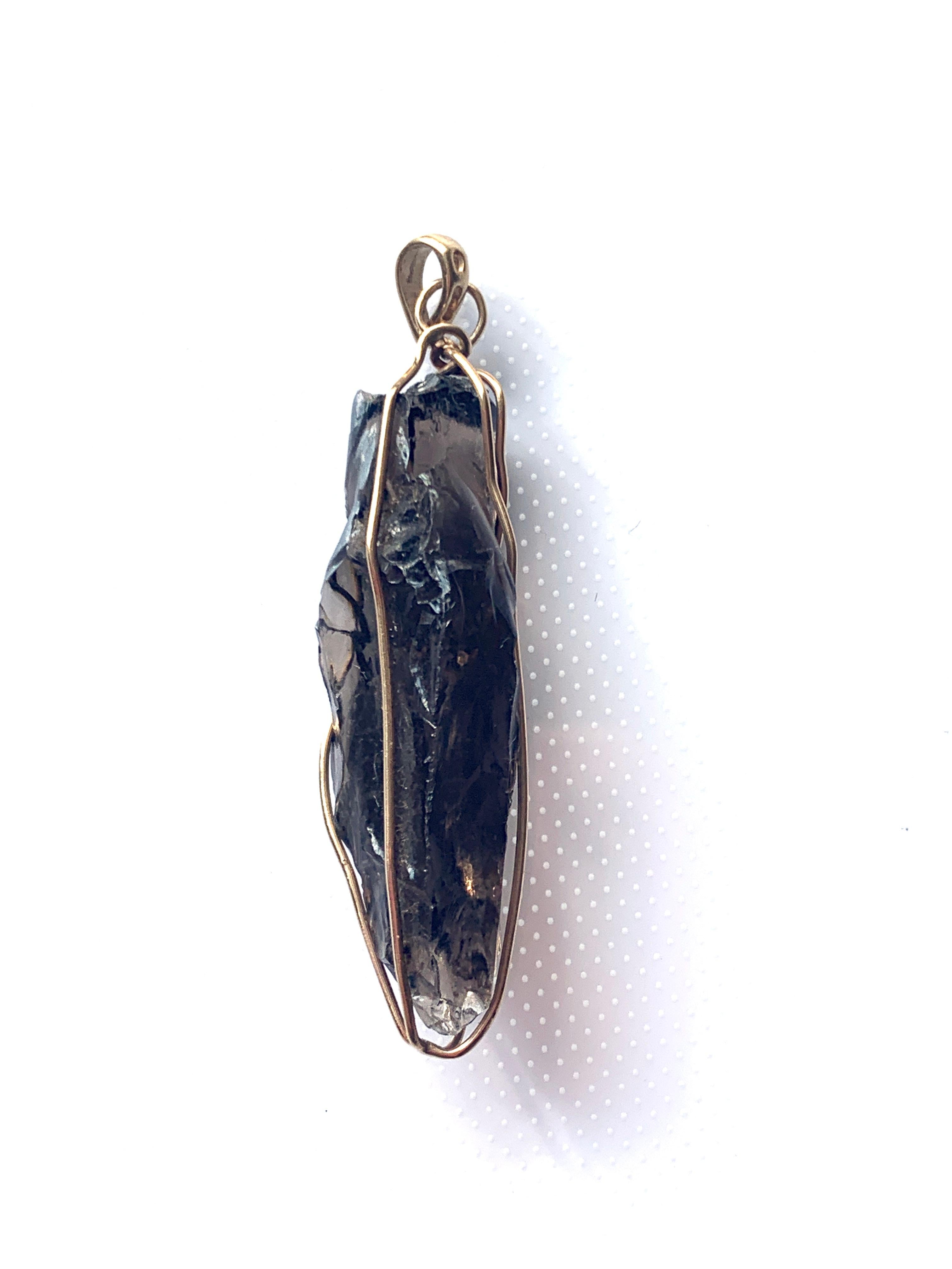 9ct 375 Gold Encaged smokey Quartz Pendant
Fully Hallmarked Makers THL
Bail has threading space of 3.5mm 
Pendant Measures 5cm x 1.5cm (at its widest point)approx
      Total Weight  8.34 grammes 
Estimated gold weight present 1.7 grammes