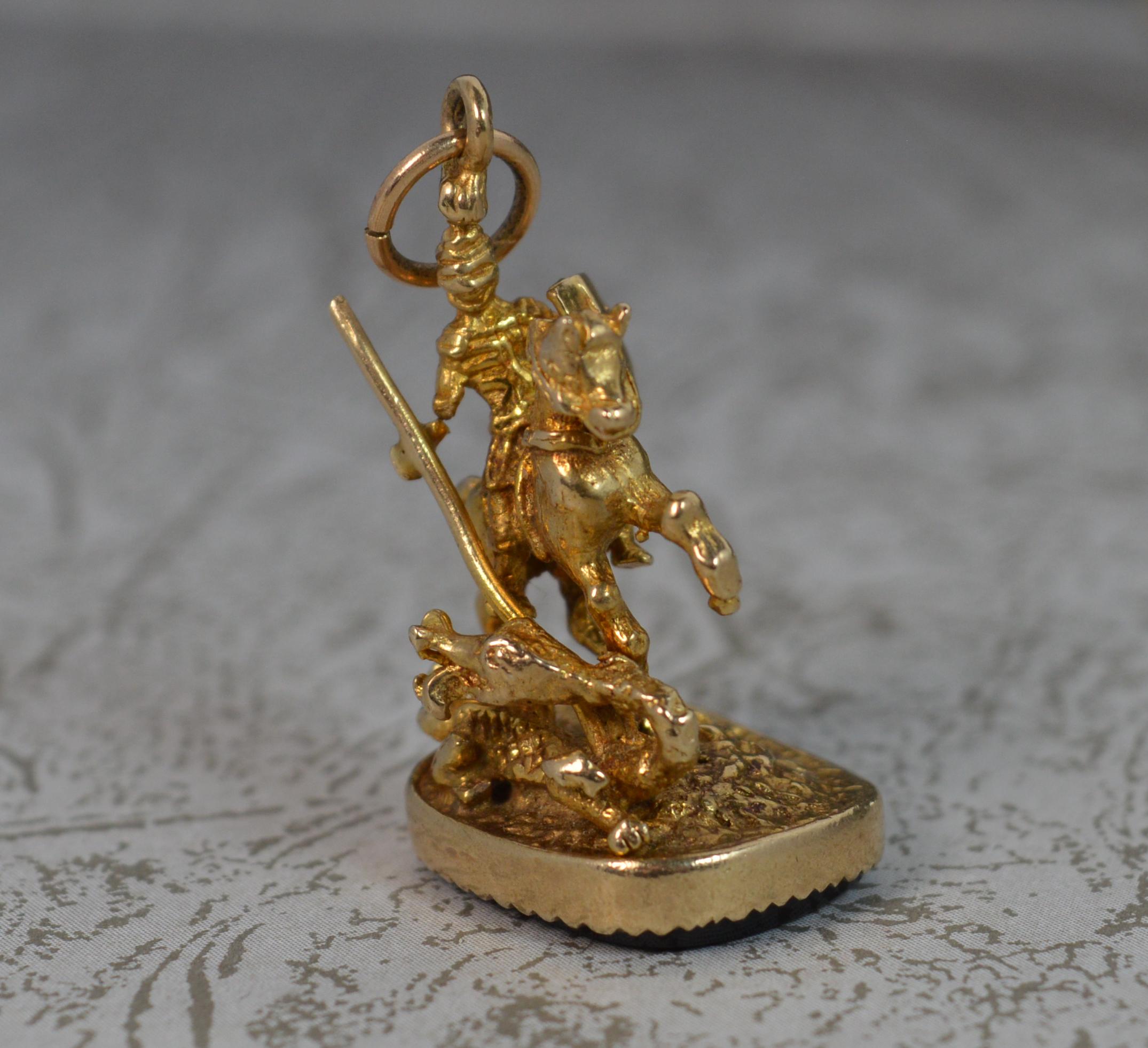 A superb modern, Victorian design pendant.
Solid 9 carat yellow gold example throughout with a rectangular base holding an onyx.
Designed as Saint George fighting the dragon.

CONDITION ; Excellent. Crisp gold section, issue free. Clean stone, well