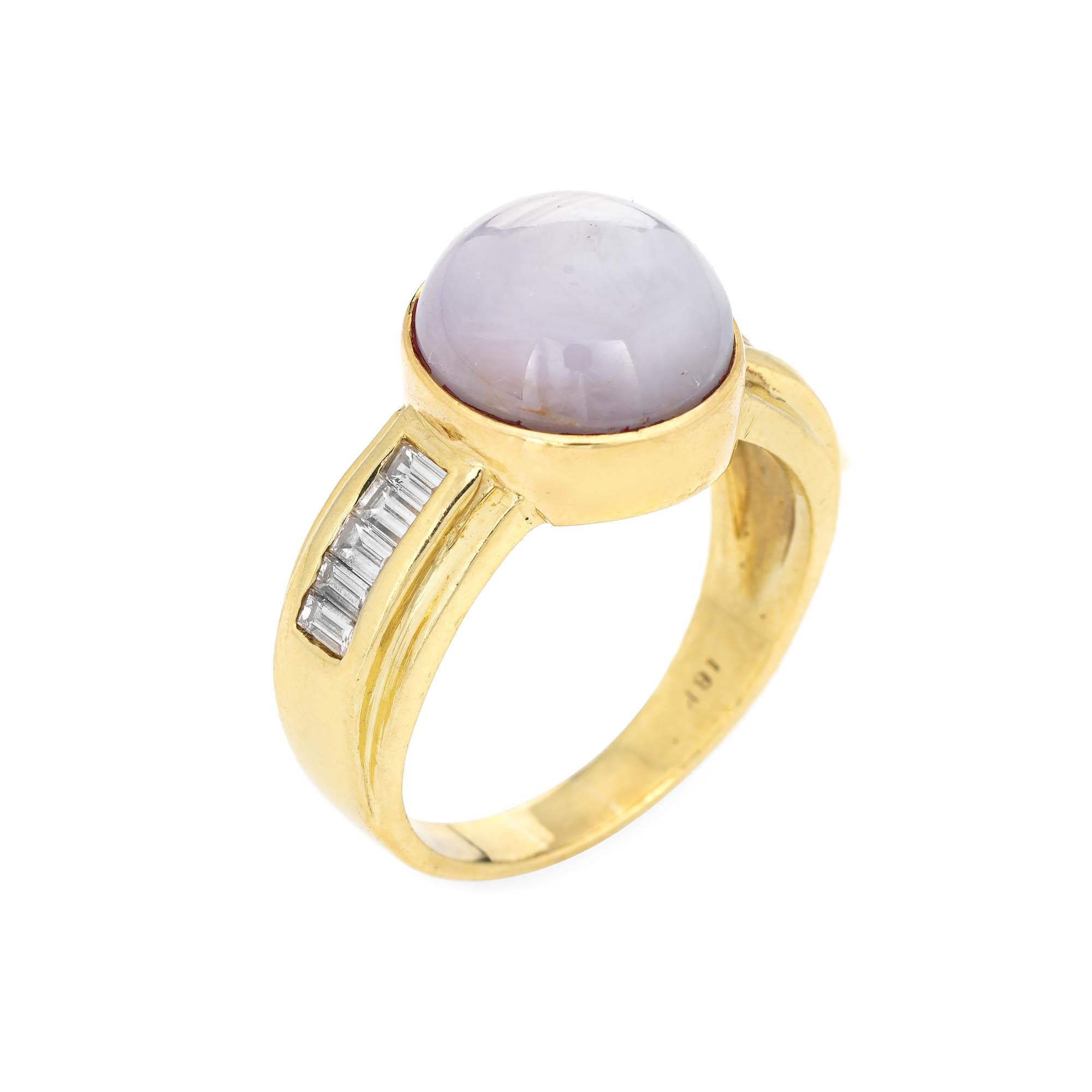 Stylish vintage natural star sapphire 7 diamond ring (circa 1980s to 1990s) crafted in 18 karat yellow gold. 

Cabochon cut natural star sapphire measures 12mm diameter (estimated at 9 carats). Straight baguette cut diamonds total an estimated 0.50
