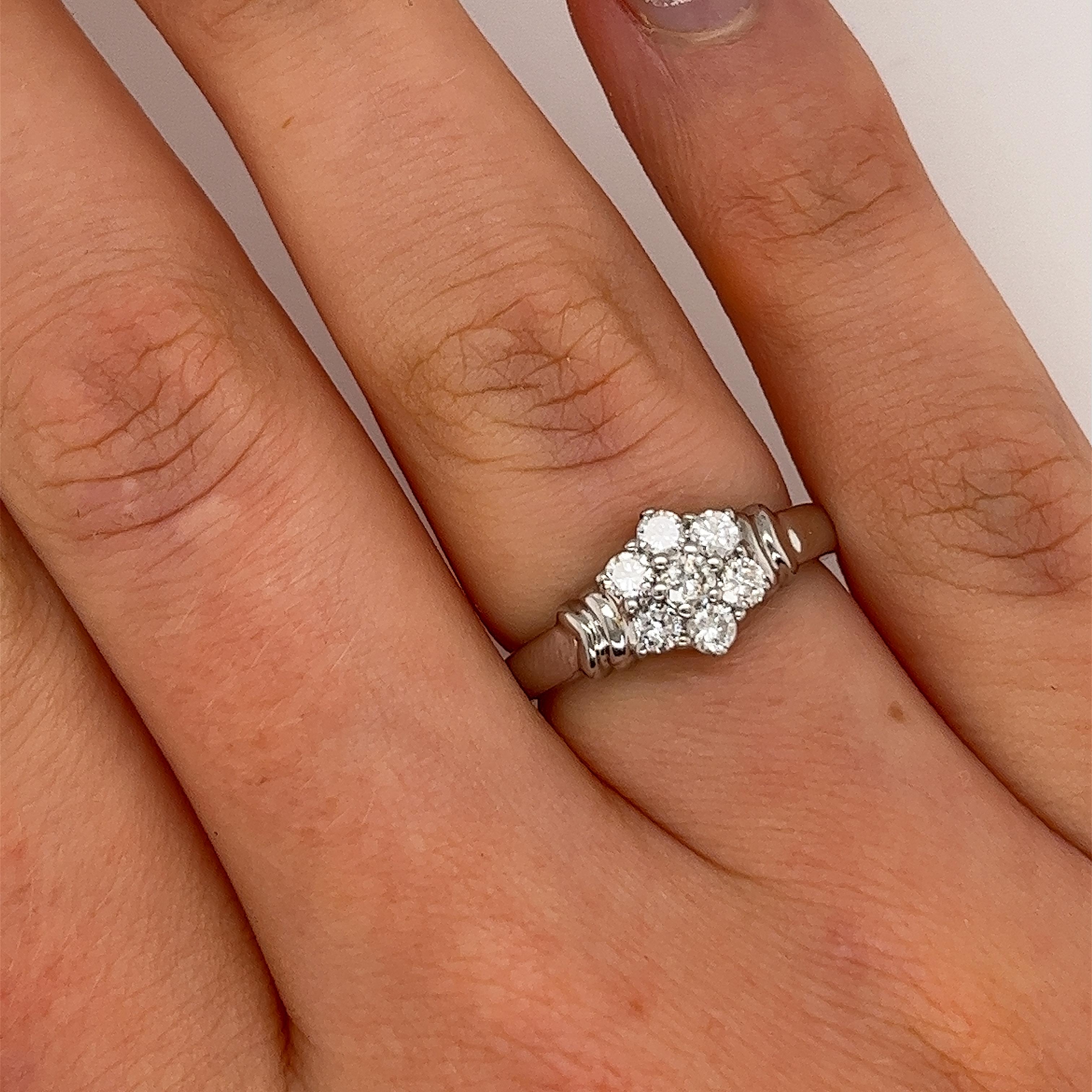An elegant diamond vintage pre-loved ring, 
set with 7 round brilliant cut natural diamonds
in a 9ct white gold setting.

Total Diamond Weight: 0.45ct
Diamond Colour: H
Diamond Clarity: SI1
Width of Band: 2mm
Width of Head: 1.86mm
Length of Head: