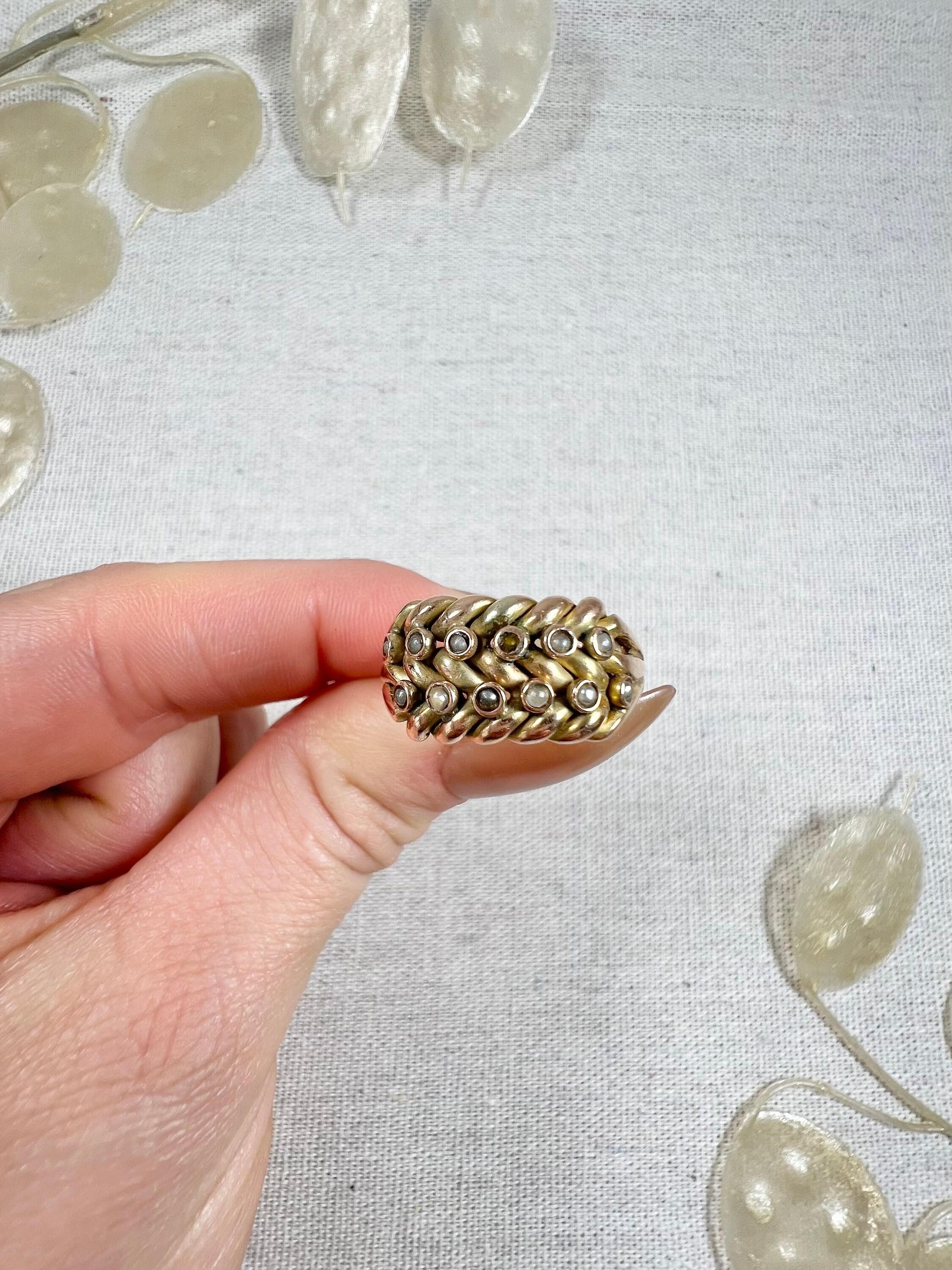 Antique Keepers Ring 

9ct Yellow Gold Stamped 

Hallmarked Birmingham 1863

Makers Mark K B S P

This antique double-row keeper's ring from the early Victorian era is a real treasure. Made from 9ct yellow gold, the ring features a beautiful and