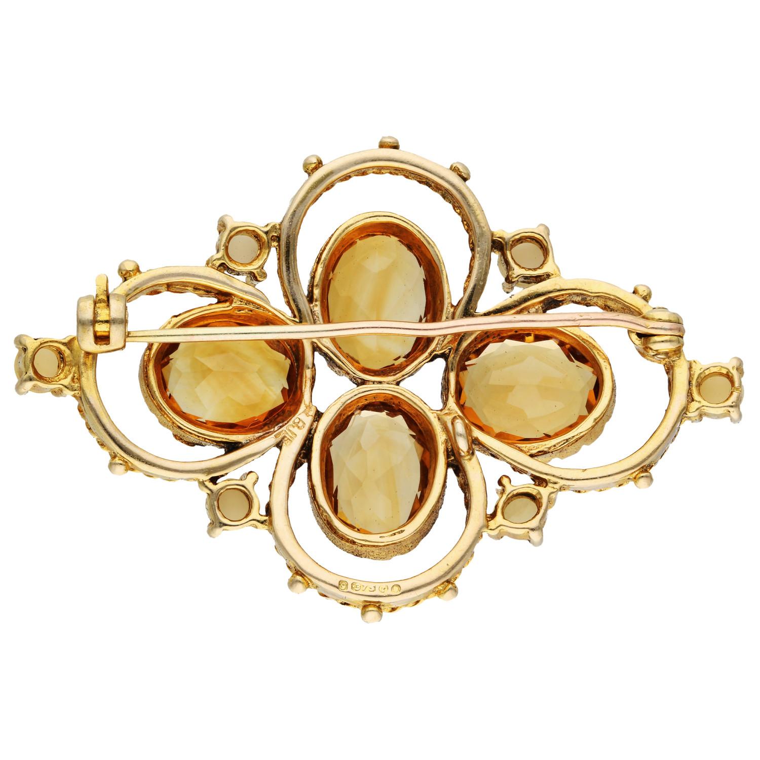 Adorn yourself with the vintage allure of this Pre-Owned 9ct Yellow Gold Citrine & Split Pearl Brooch. This exquisite piece is a symphony of elegance, featuring a quatrefoil flower design meticulously crafted with four oval faceted citrines,