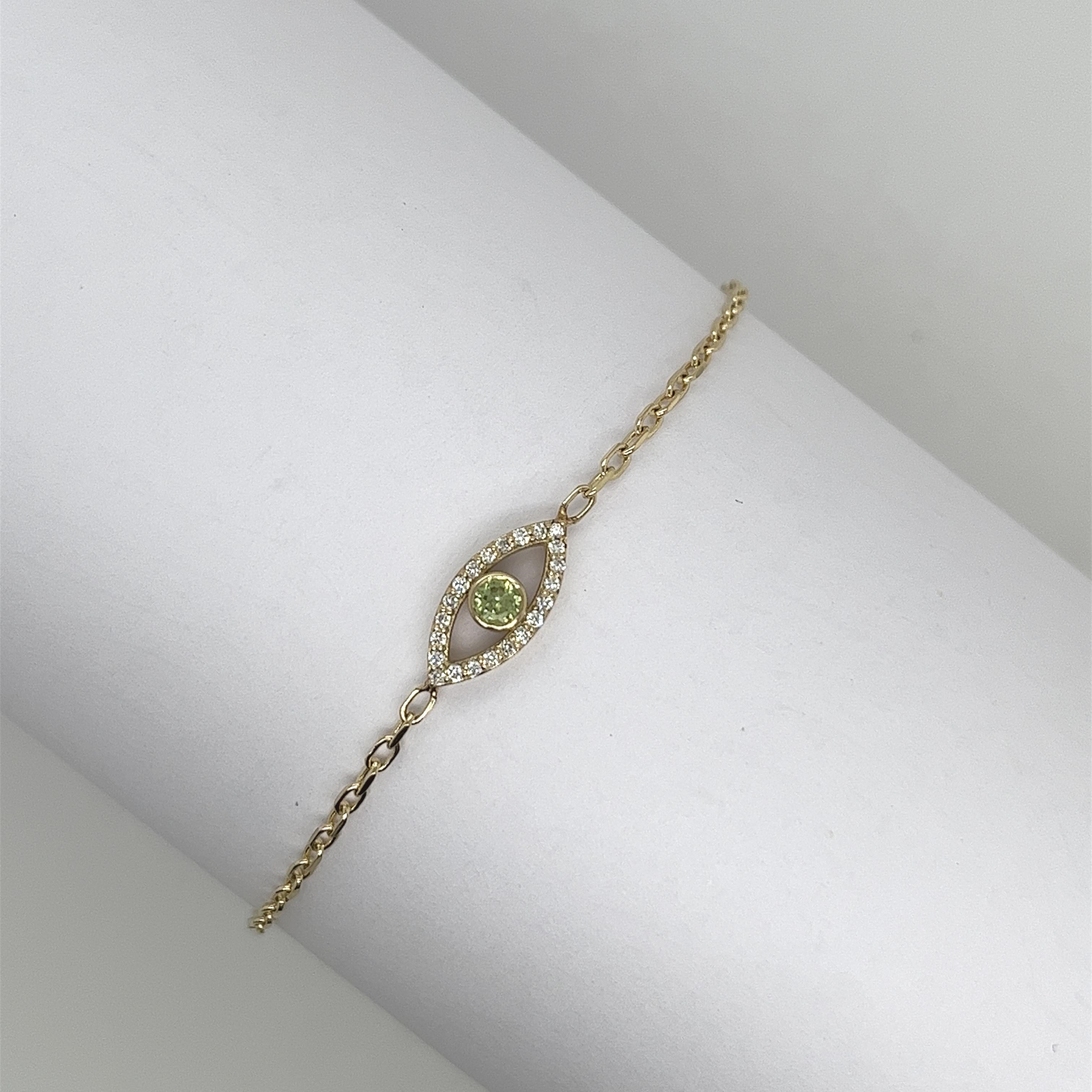 Made by Jewellery Cave- our exquisite 0.08ct diamond set and round peridot evil eye bracelet—
an enchanting fusion of style and symbolism. 
Crafted in 9ct yellow gold, the centrepiece of this mesmerizing bracelet is the striking Evil Eye charm,