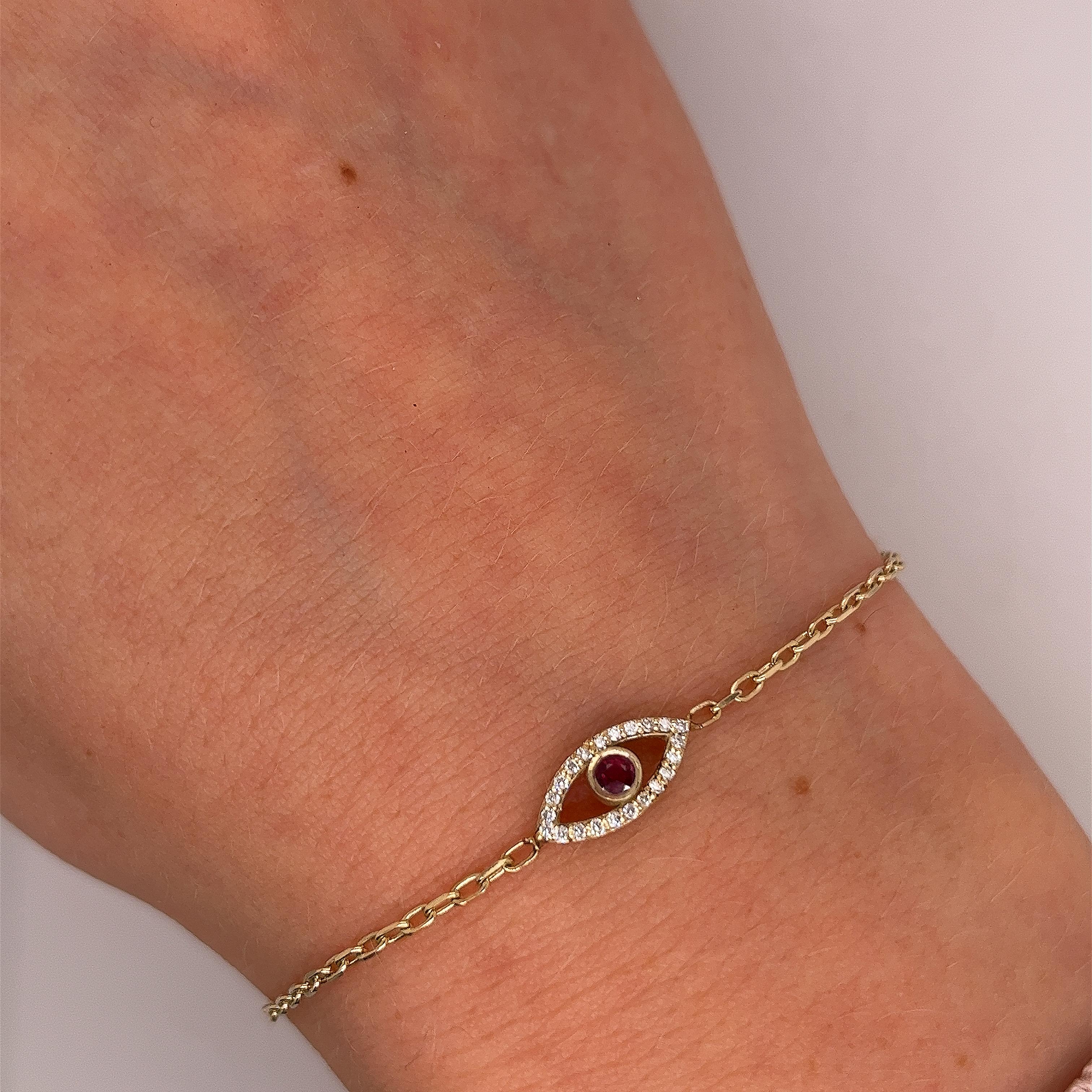 Made by Jewellery Cave- our exquisite 0.08ct diamond 
set and round ruby evil eye bracelet—
an enchanting fusion of style and symbolism. 
Crafted in 9ct yellow gold, the centrepiece of this mesmerizing 
bracelet is the striking Evil Eye charm,