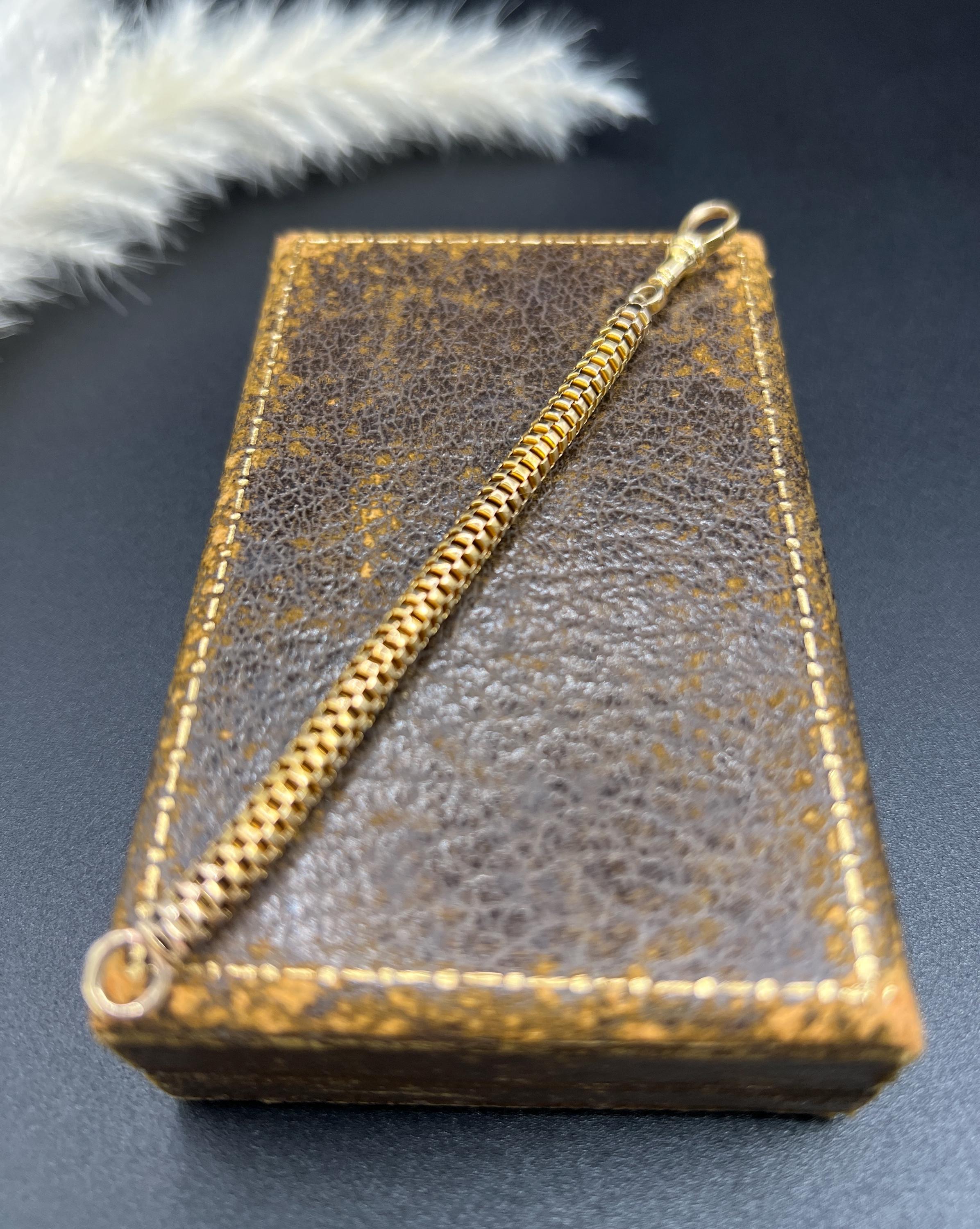 Antique Gold Chain Extender

9ct Yellow Gold

Circa 1900

Add a touch of versatile elegance to your jewellery collection with this exquisite 9ct yellow gold snake link extender chain. This beautiful chain is designed to be worn as either a pendant