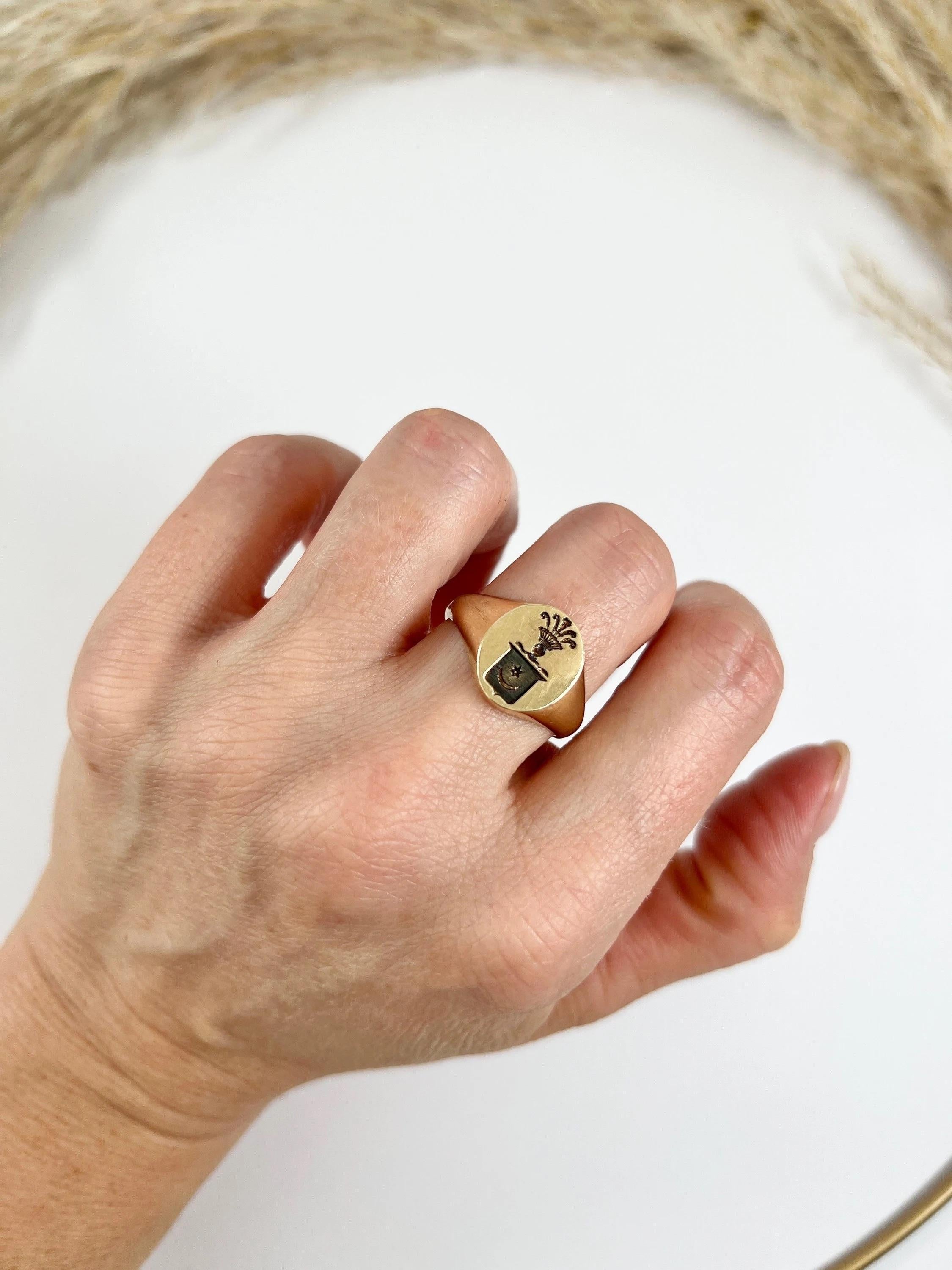 Antique Signet Ring

9ct Gold Stamped

Hallmarked London 1971

Makers Mark W W Ld

This vintage 9ct yellow gold, oval seal signet ring is truly one-of-a-kind. The family crest on this ring features a star and crescent moon (or sun and moon), which