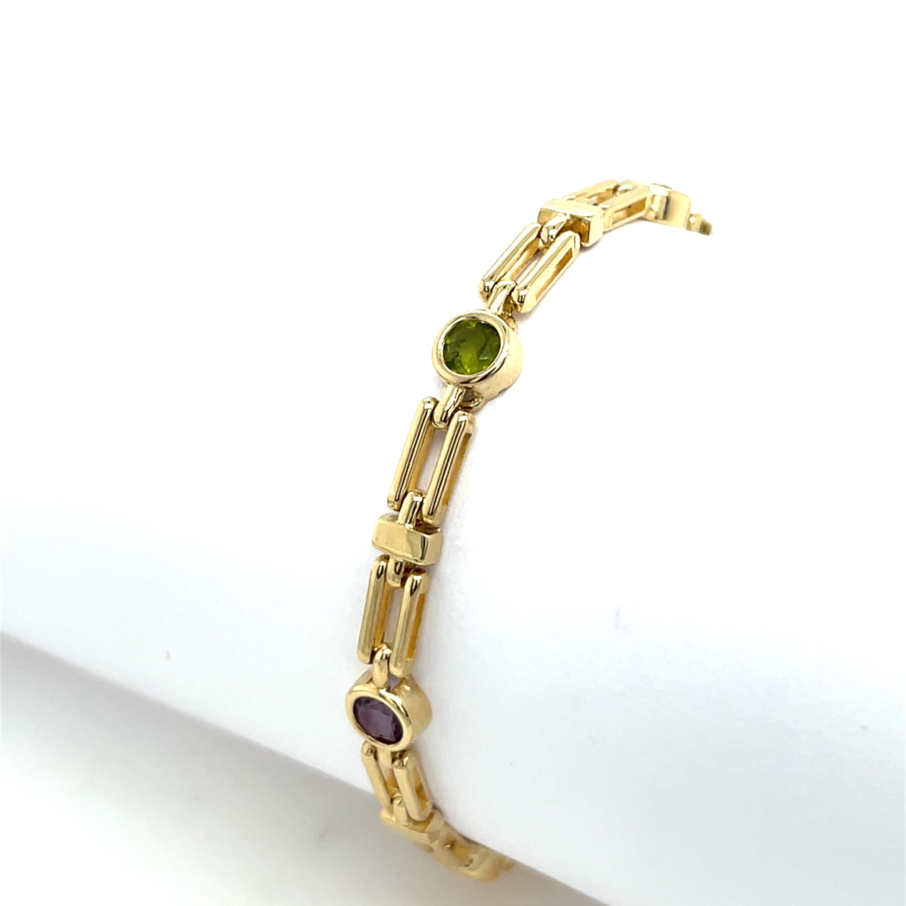 Vintage vibrant 9ct yellow gold bracelet, elegantly set with a combination of amethyst, peridot, and citrine gemstones, creating a stunning contrast against the warm gold setting. 
A beautiful and timeless piece, perfect for adding a touch of colour