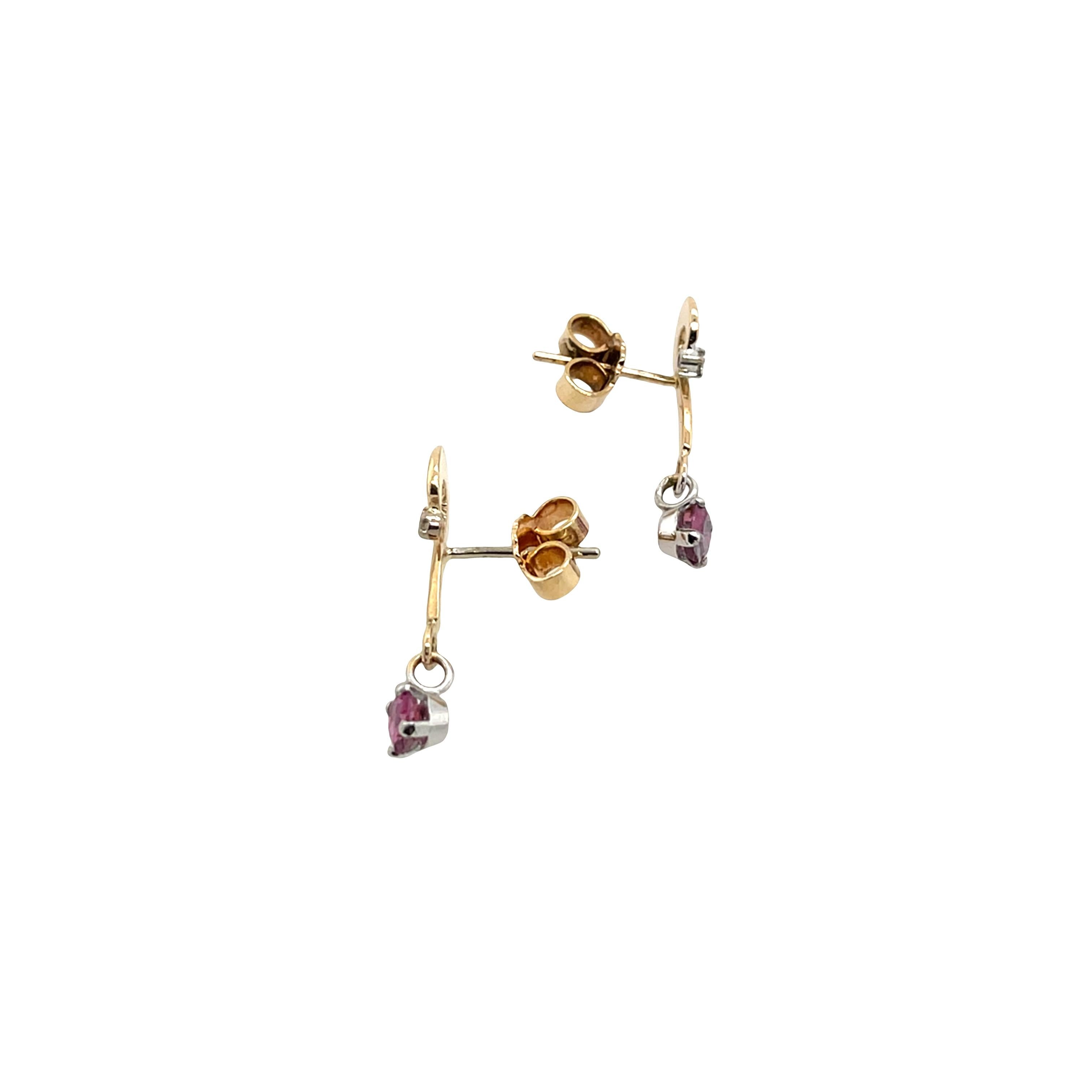 9ct yellow & white gold earrings set with 2 Rubies and 2 Diamonds. 
These elegant earrings feature a two-tone gold design that beautifully complements the vivid red of the rubies and the sparkle of the natural diamonds. 

Total Diamond Weight:
