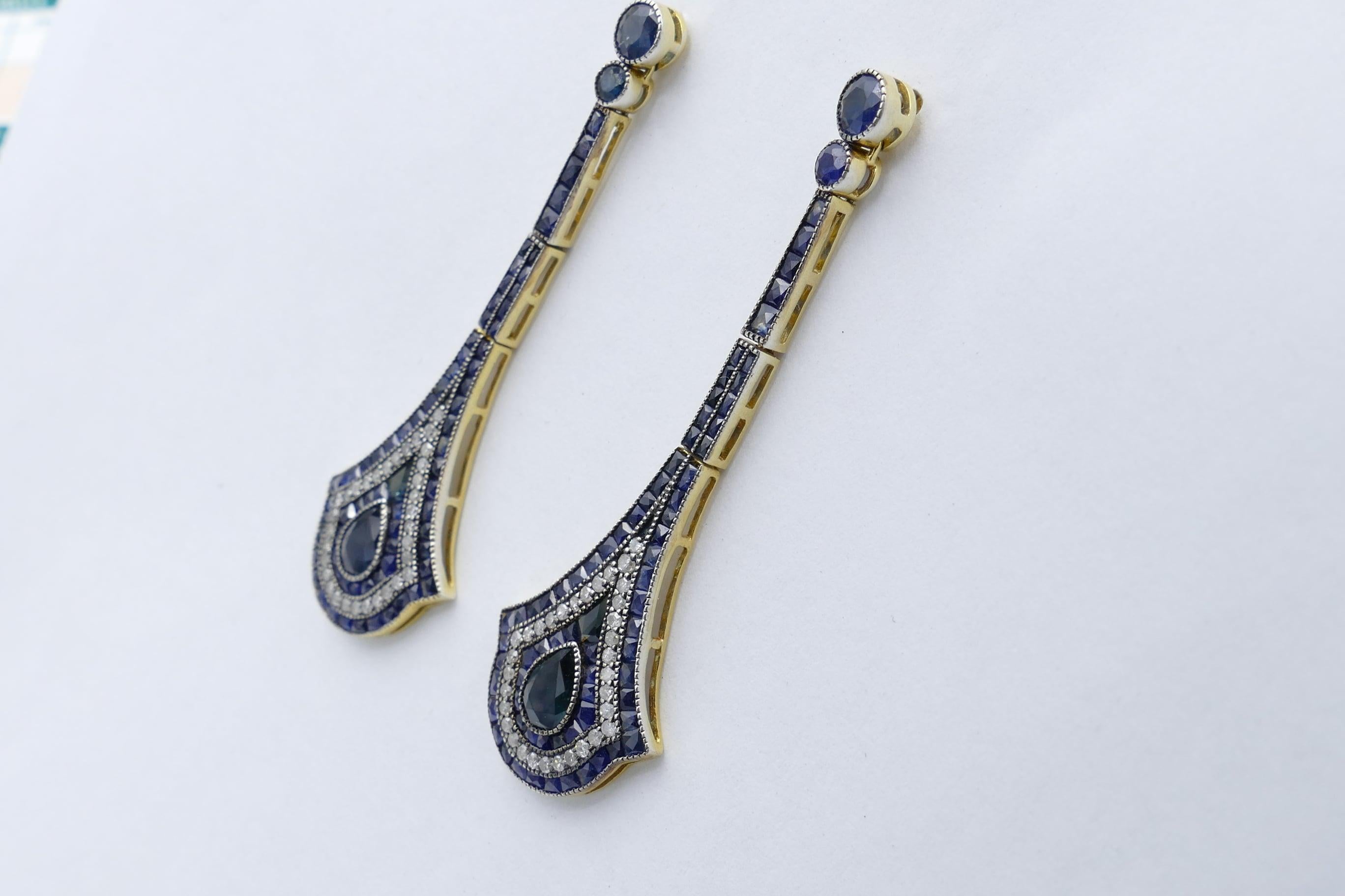 A multitude of Sapphires is the major attraction of these gorgeously attractive earrings.
Deep blue - close to navy, is the predominant colour of the sapphires and they are set in several different ways - brilliant cut, carre cut, pear cut and the