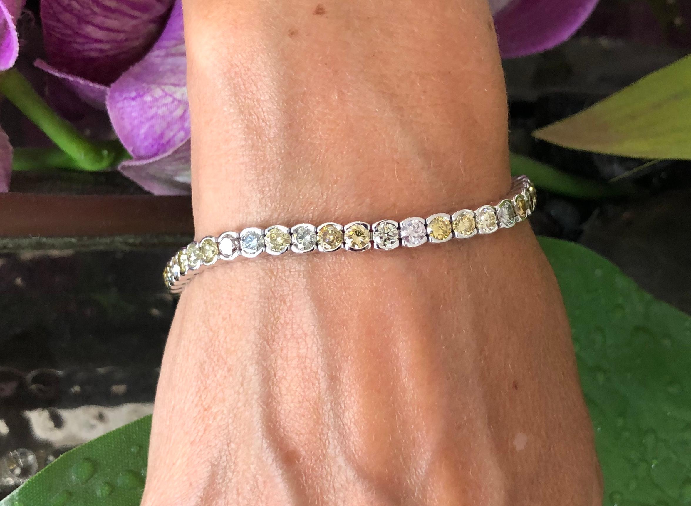 Offered here is a gorgeous bezel set diamond tennis bracelet in 18kt white gold. The bracelet is set with fourth nine ( 49 ) natural round brilliant cut diamonds. All the diamonds are natural color ranging from light brown to dark brown, different