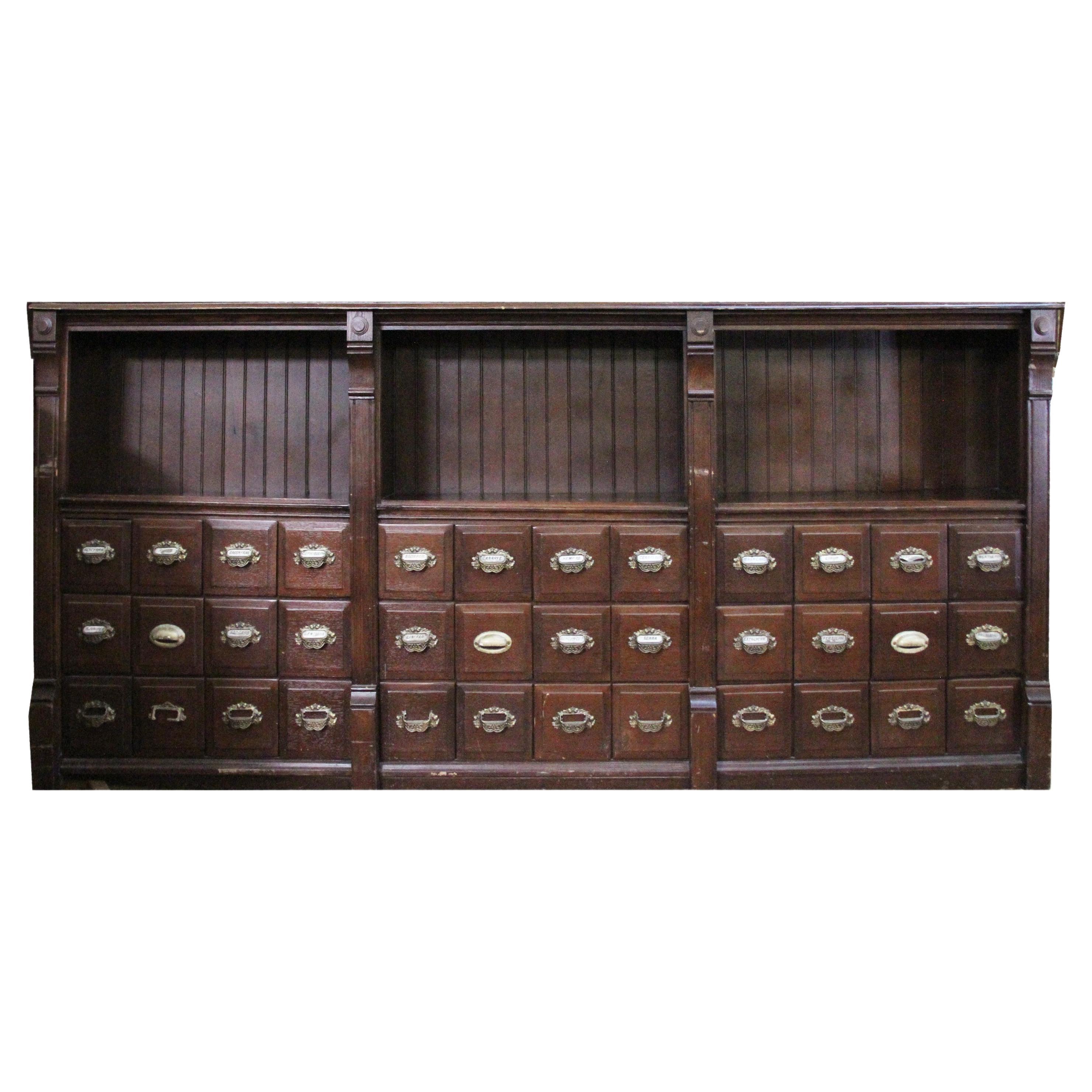 9FT Antique Apothecary cabinet

Fantastic cabinet from a Texas University Pharmacy College. One piece with 3 sections and 36 drawers. Hand carved details. Retains original category labeling with beautiful brass pulls. The top features open shelving