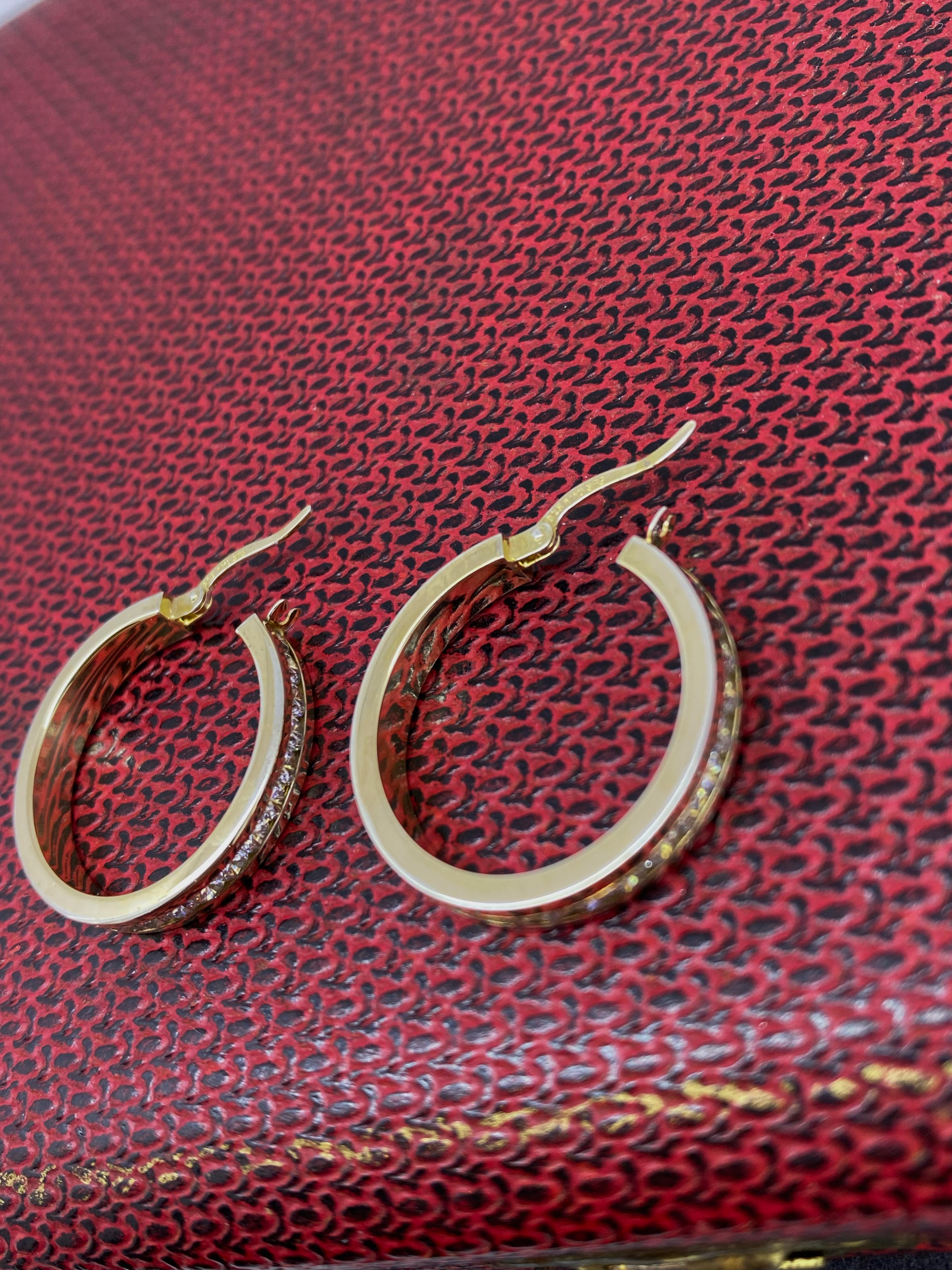 These exquisite 9K Gold-Plated & Sterling Silver Hoop Earrings 
can become an ideal present for your loved one, 
as its striking design speaks for itself...

Each features CZ's channel-set all around

Measuring 25mm in length, 
these earrings
