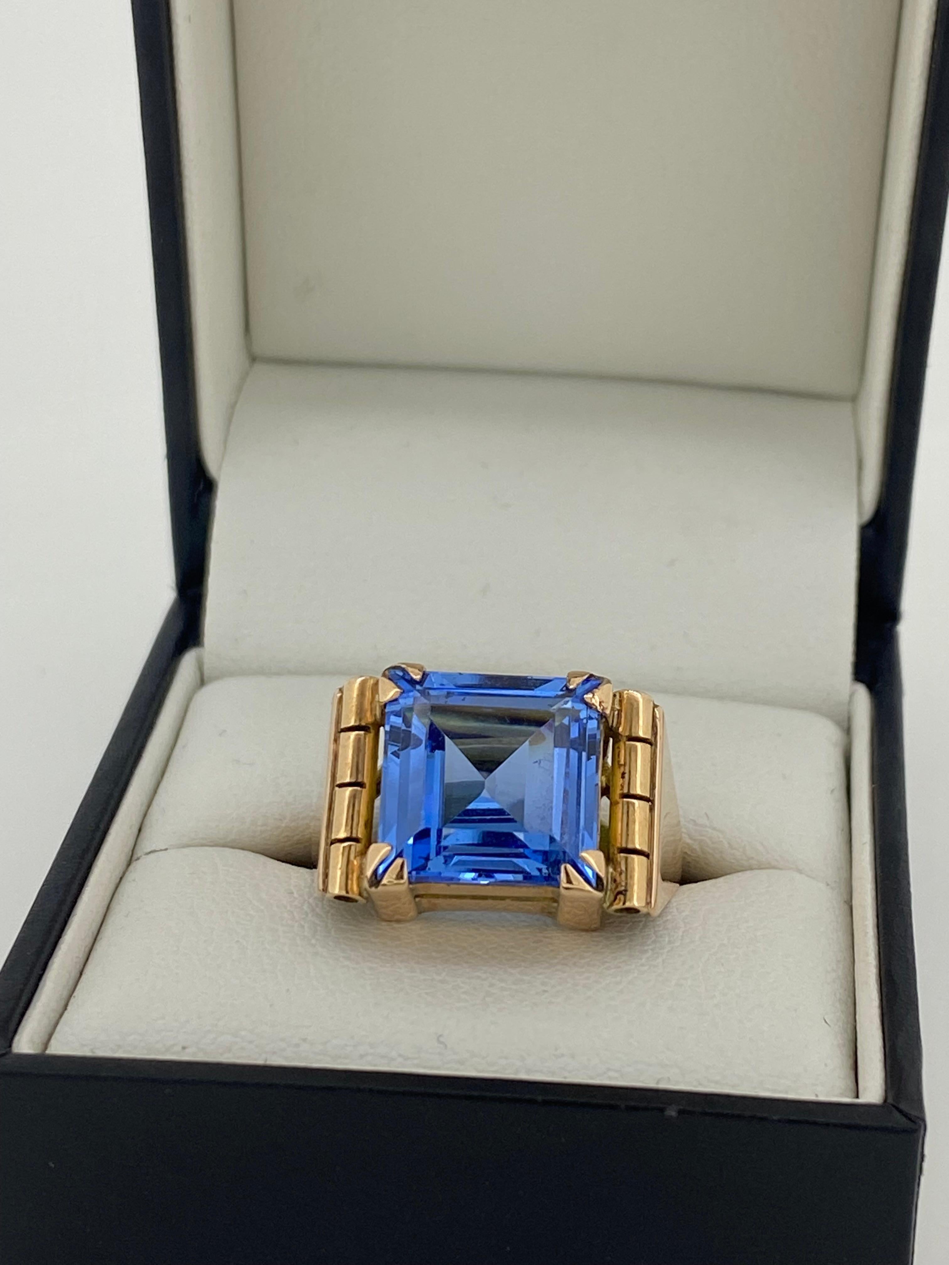 Of an exquisite & comfortable design, 
this mens' retro ring comes from 1950's

Crafted in 9K Yellow Gold 
it's centrally prong-set with a Square Synthetic Sapphire 
of impressive 5.00ct approx.
(11.5mm x 11.5mm)
of vibrant sky blue colour