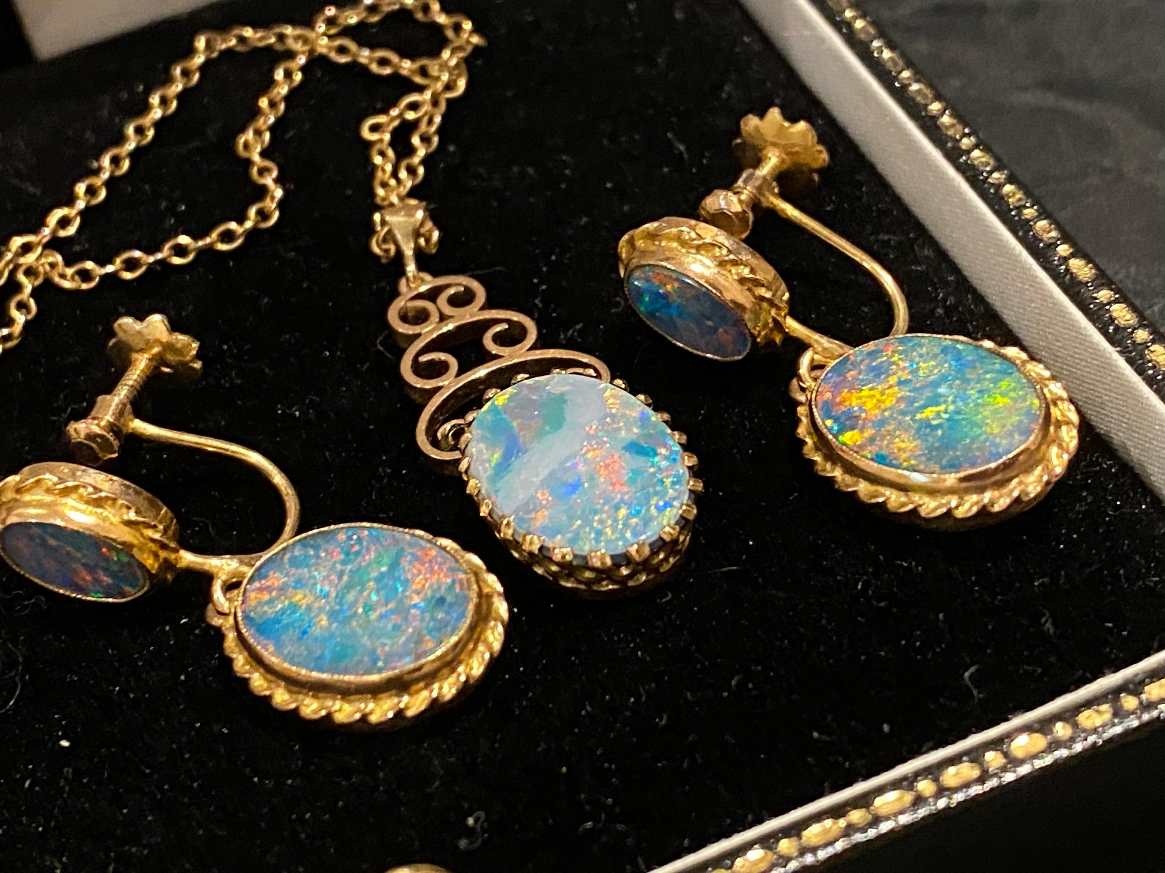 Of Australian provenance, this retro 1960’s opal set comprises: 

A Pendant, set with Australian Opal (doublet),
of oval shape, 
measuring impressive 15mm x 10mm,
mounted in 9K rose gold elaborate setting, 
pendant’s height: 33mm

The pendant is on