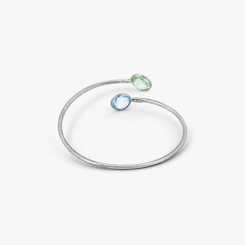 9K satin white gold Kensington bangle with topaz and green amethyst

A wrap-around bangle made from 9K white gold finished with green amethyst and blue topaz stones at either end. As the latest addition to our Kensington Collection, each piece
