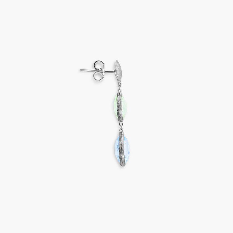 9K satin white gold Kensington drop earrings with topaz and green amethyst

This beautiful pair of 9K white gold earrings have been handset with small blue topaz and green amethyst stones by our artisans into this short drop style. As the latest