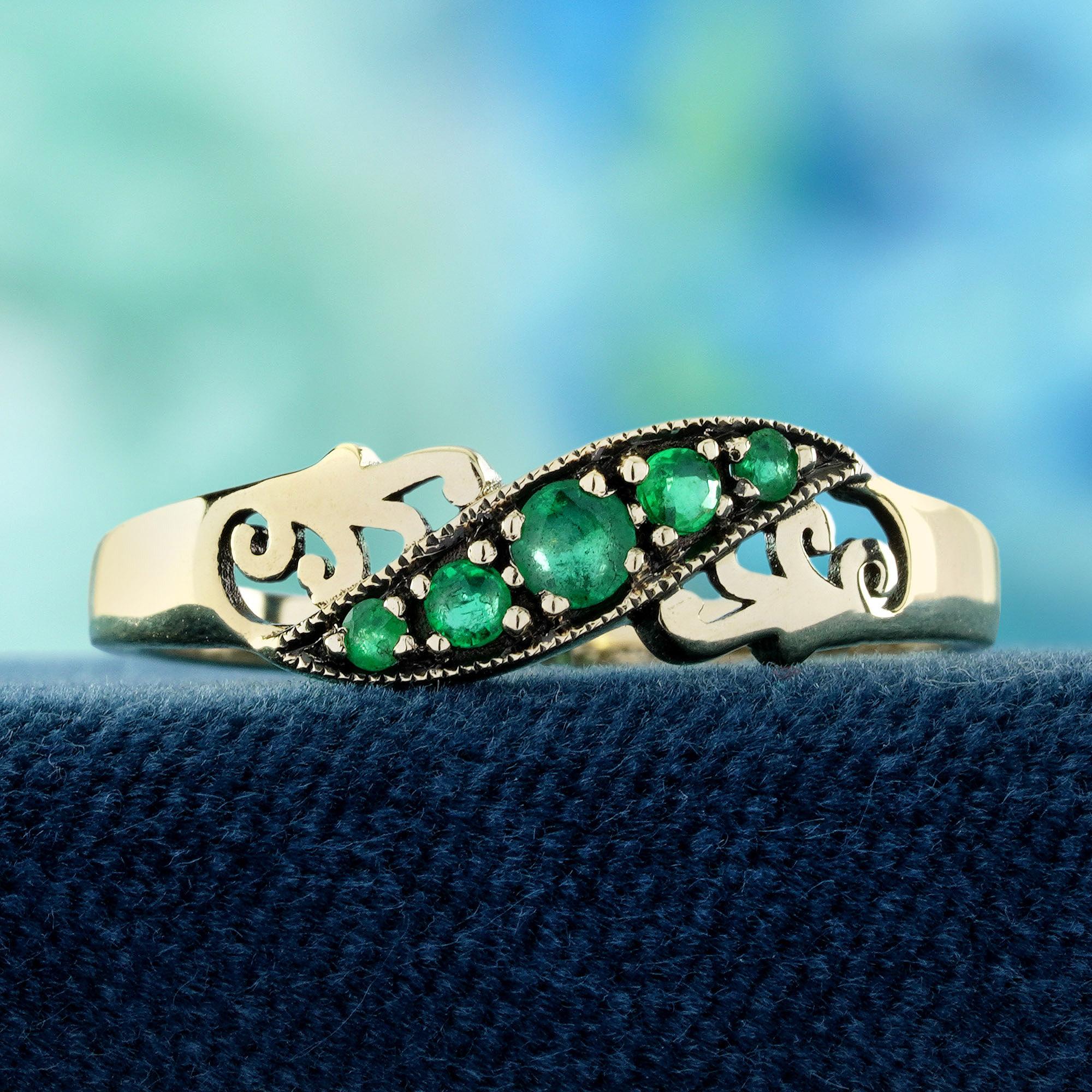 Gracefully sculpted with vintage charm, this ring features a rich emerald nestled in an elegant curved silhouette, like a gentle vine wrapping around the finger. The deep green hue evokes nature’s quiet luxury, while the curve adds a touch of
