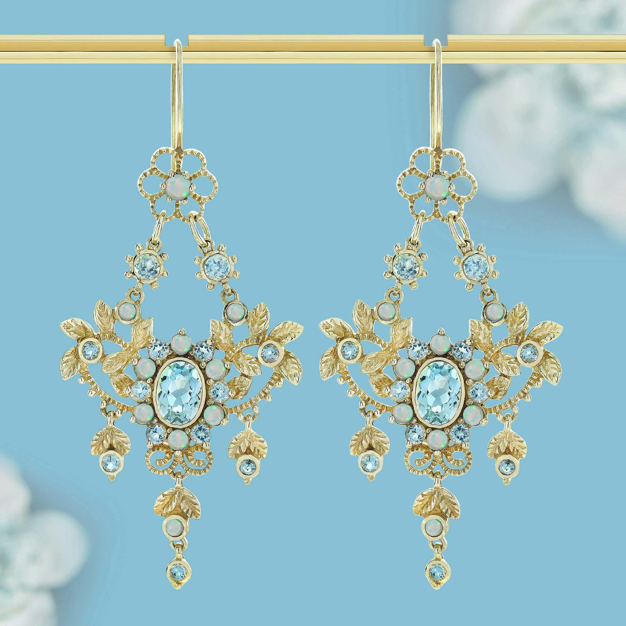 Estos exquisitos pendientes de araña de estilo vintage presentan un radiante topacio azul natural en el centro, rodeado de luminosos ópalos que forman un delicado motivo floral. Los ópalos, con sus tonos resplandecientes, realzan el vibrante topacio