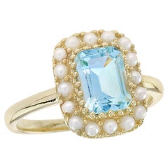 Bague de style vintage en or jaune 9K avec topaze bleue naturelle et halo de perles