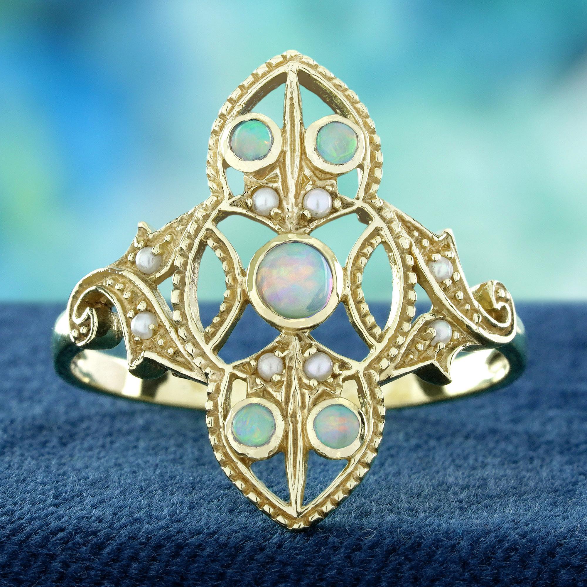 Floral ring features a radiant round natural opal at its center, beautifully encircled by shimmering pearls. The intricate filigree work on the shoulders adds delicate, vintage-inspired floral details. Combining the opal’s ethereal glow with the