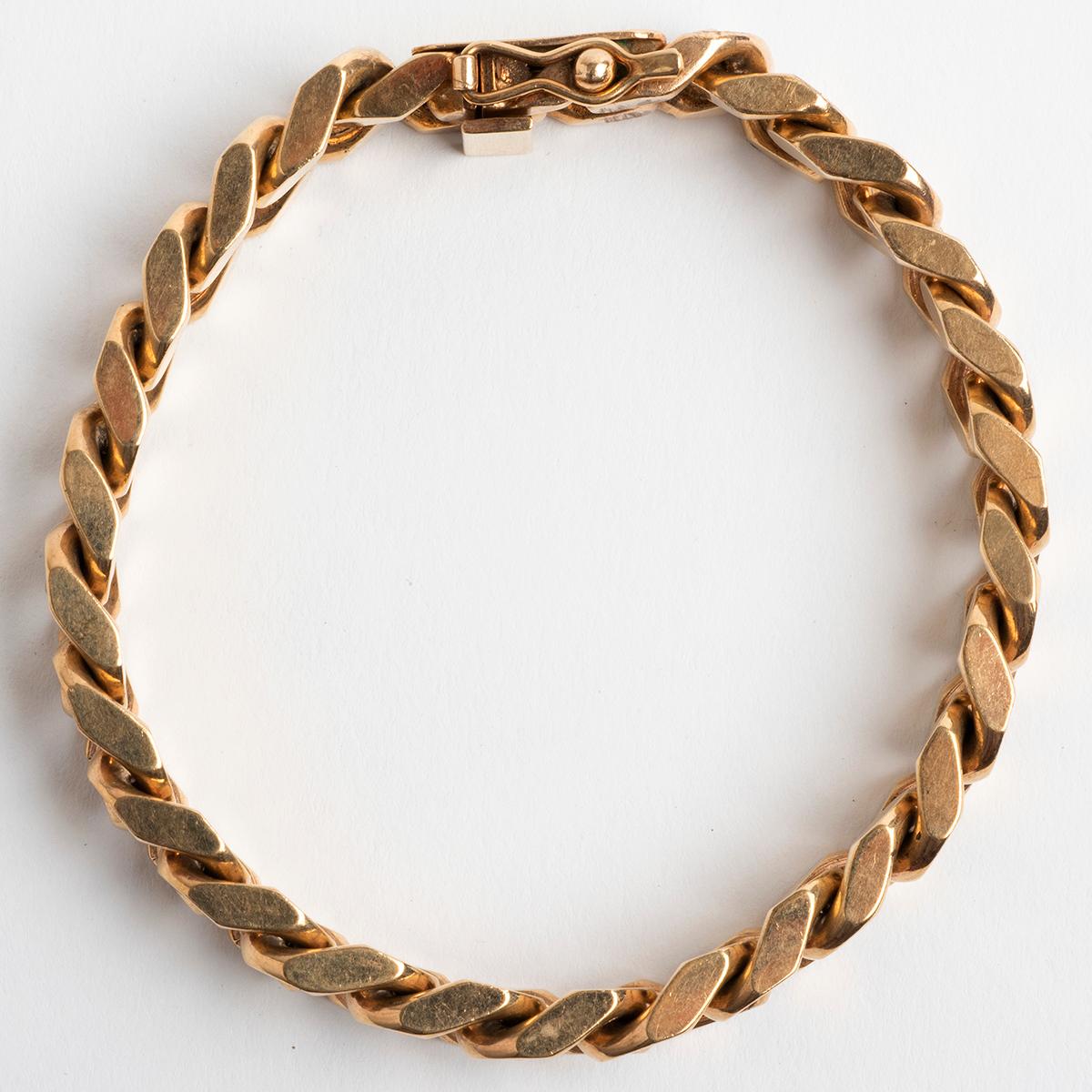 Our classic 9k yellow gold solid link curb bracelet has a box and tongue clasp with figure of eight safety. Total weight 53.8g and hallmarked Sheffield. We date to circa 1970s. Length is 19cm.

A unique piece within our carefully curated Vintage &