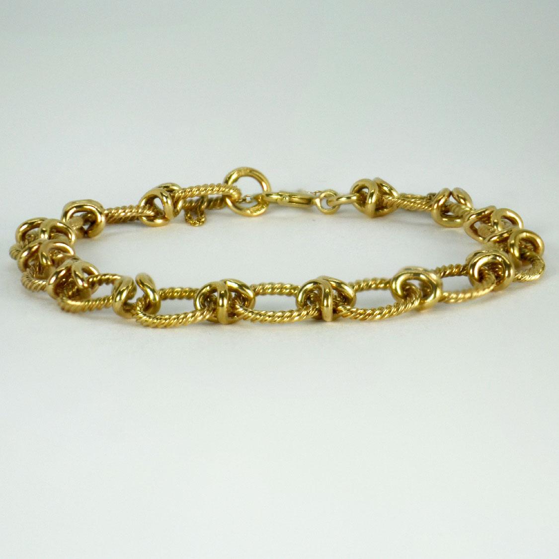 A 9 karat (9K) yellow gold fancy link bracelet designed with twisted oval links. Hallmarked for Birmingham, 9 karat gold, 1963 with unknown makers mark JG&S. 7.25” long.

Dimensions: 18.5 x 0.8 cm
Weight: 13.02 grams
