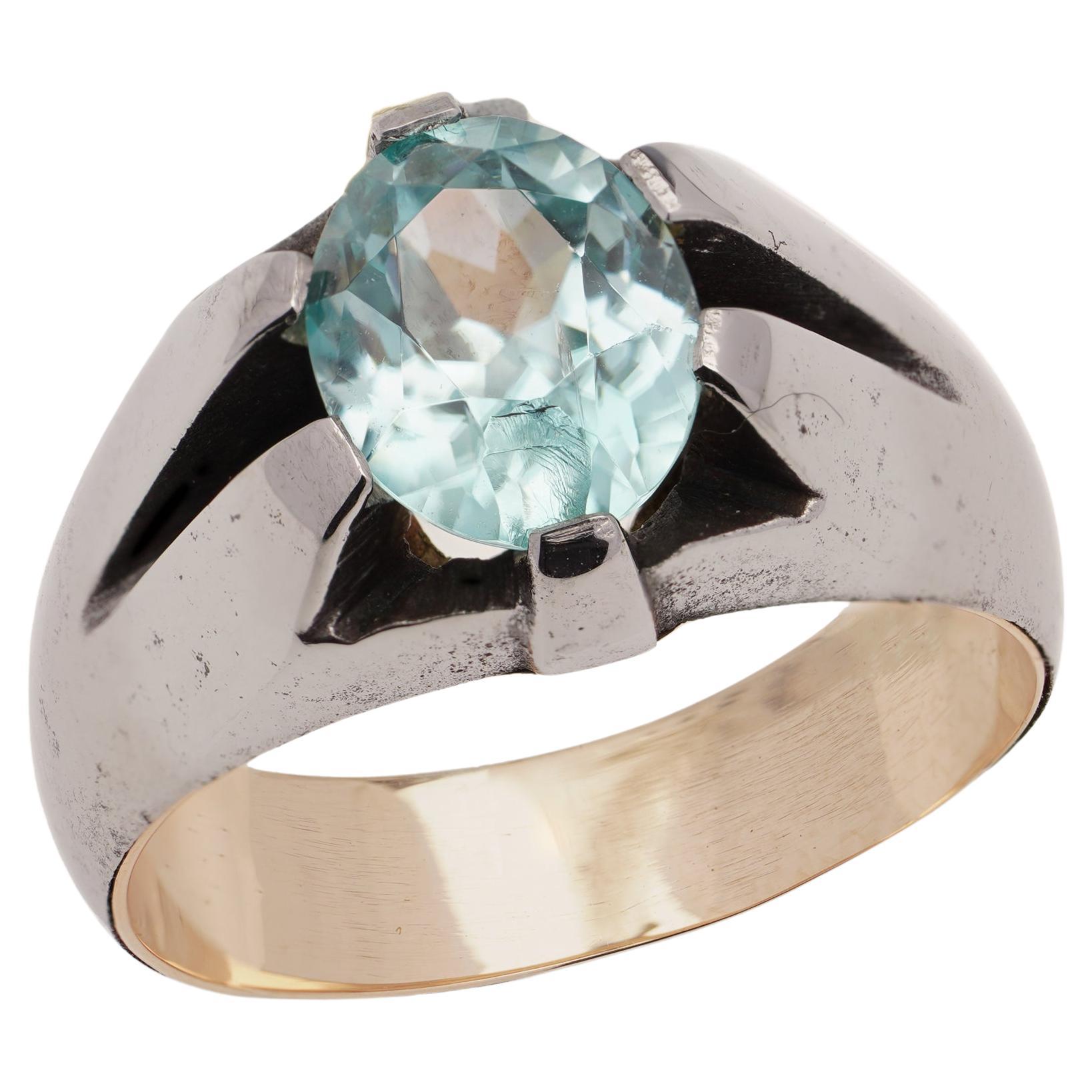 9kt pink gold and iron ring set with oval faceted 1.40 ct. blue topaz. For Sale
