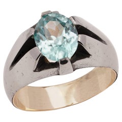 9kt pink gold and iron ring set with oval faceted 1.40 ct. blue topaz.