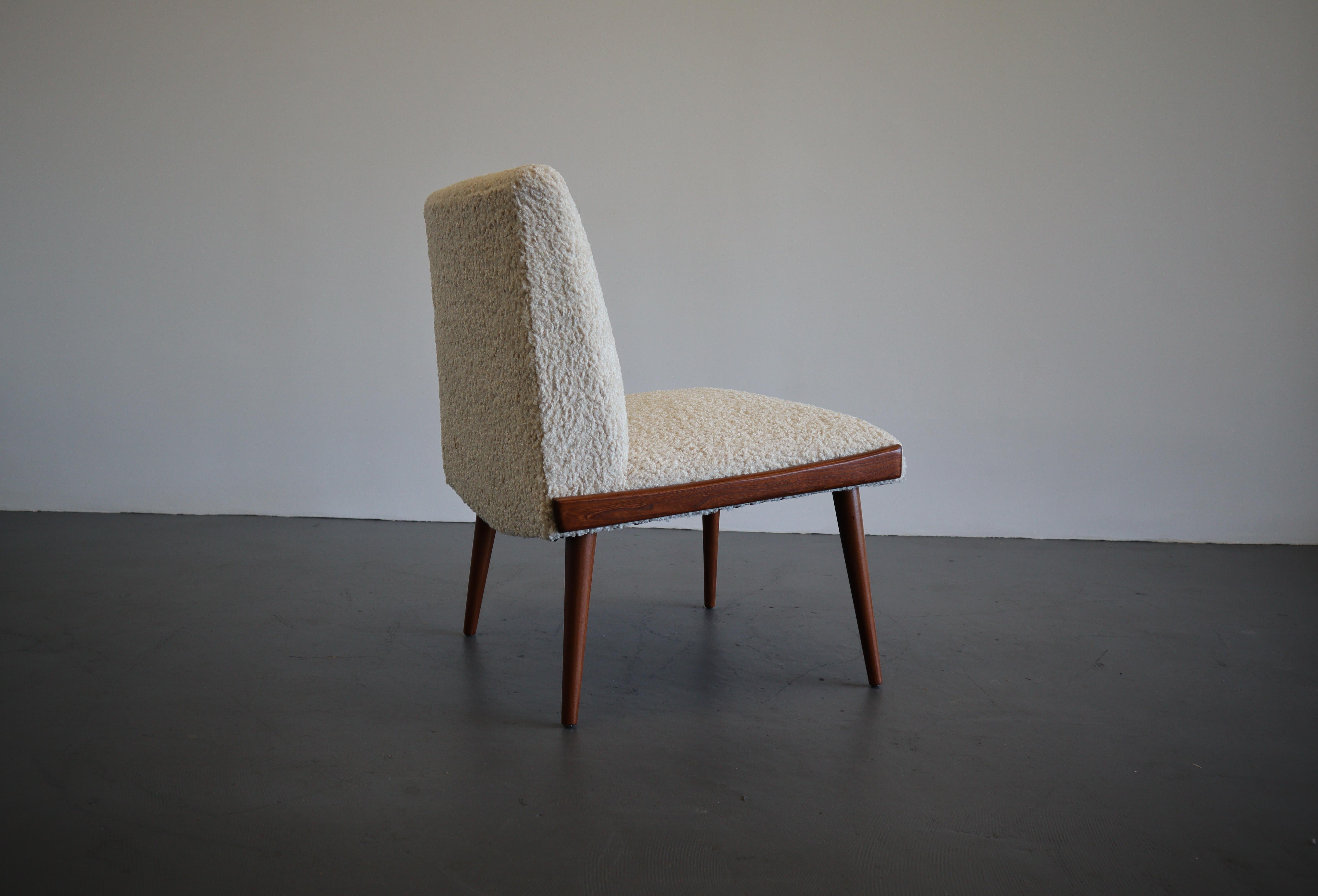 A beautiful single side chair by Kroehler. Sumptuous tailored boucle upholstery oozes luxury and comfort. A classic design that has endured and continues to prevail as an iconic mid century modern staple.
