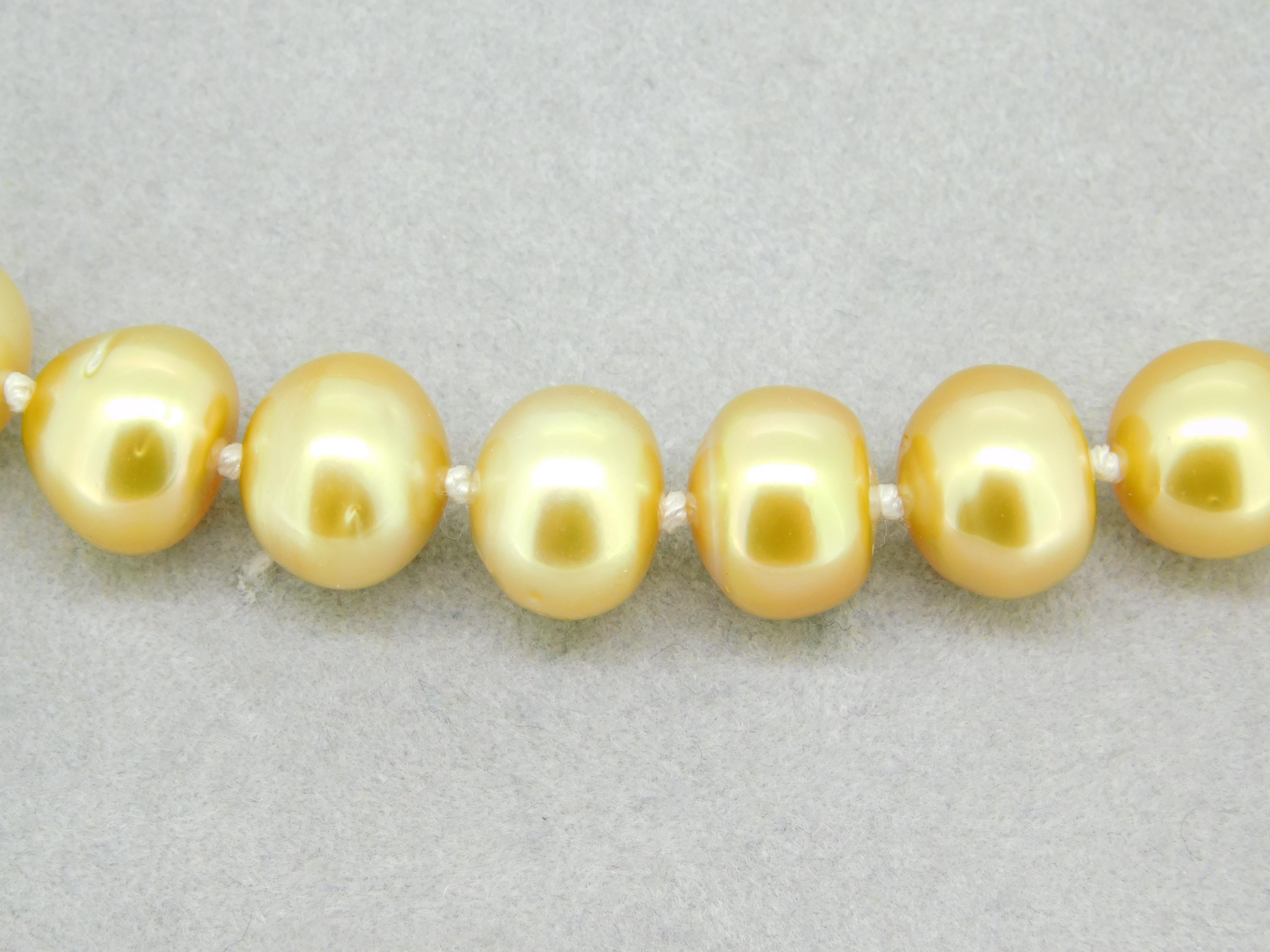 9mm Golden South Sea Strand of Pearls Necklace w/ 14k Yellow Gold Clasp (#J4569)

Strand of Tahitian south sea golden cultured pearls. The pearls are round to semi-round shape cultured in French Polynesia. Natural light golden color, not treated or