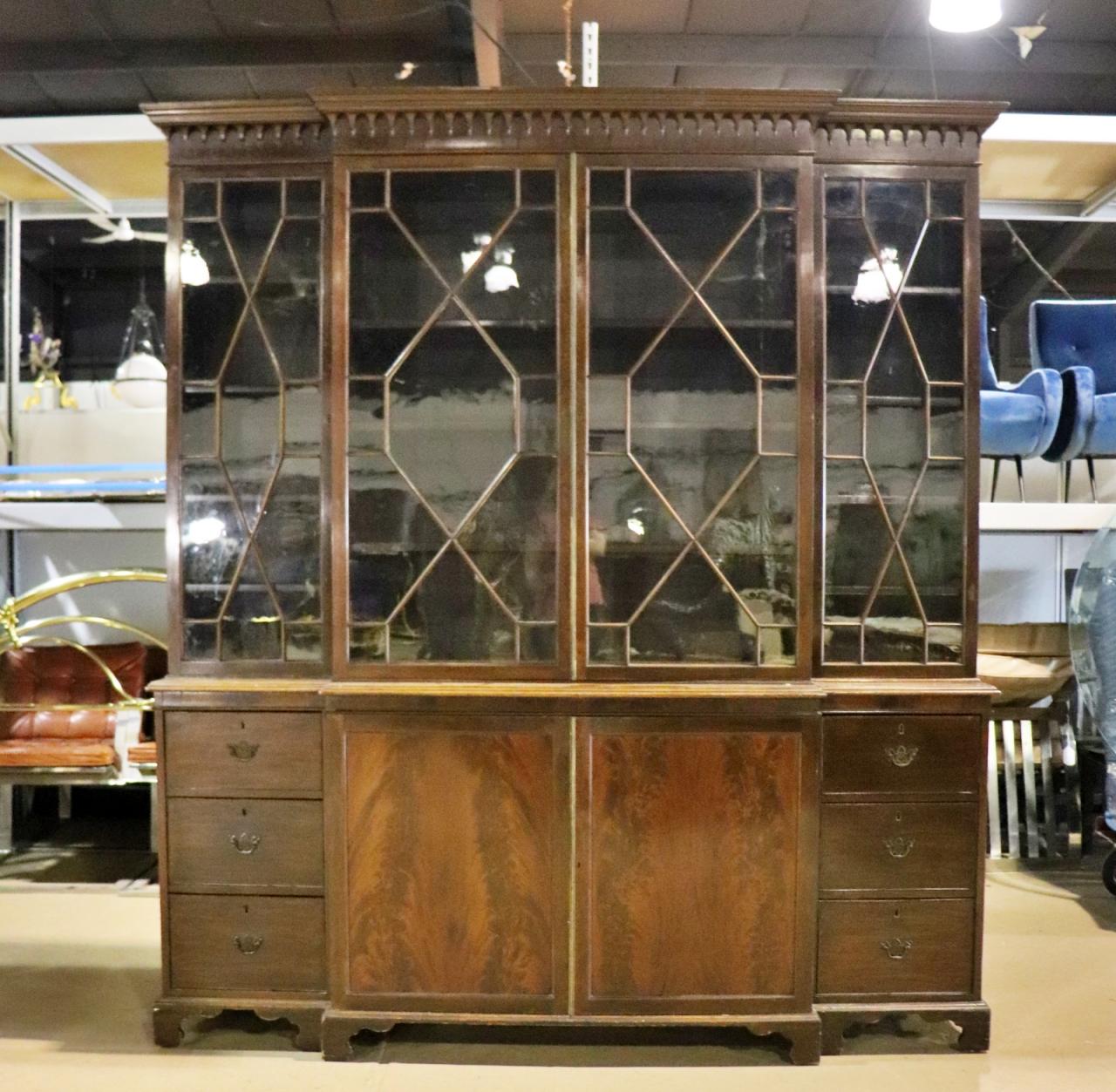 Carved. Wood.  4 glass doors. 2 side doors contain 4 shelves. Middle has 2 shelves. 3 drawers on each side. 2 doors on bottom middle has 2 shelves. Metal hardware. 88 1/2