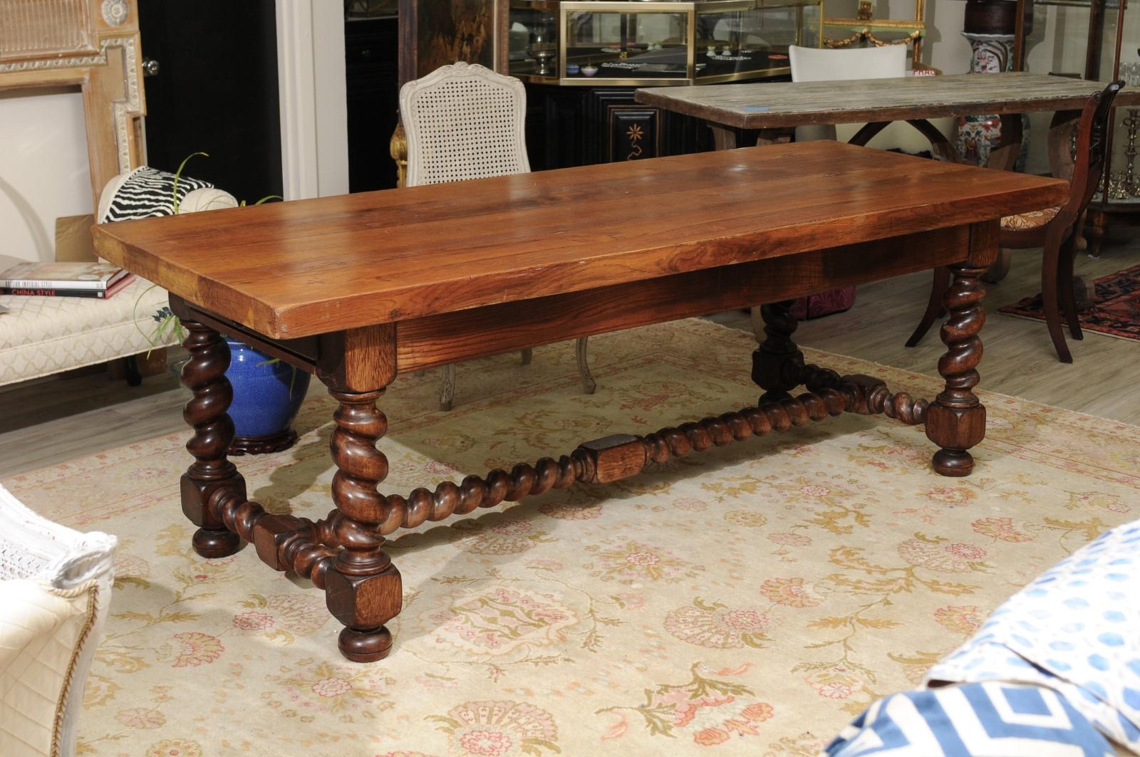 A magnificent French Country Refectory table. The large solid walnut 2 1/2 inches top sits on 4 distinctive large thick barley twist legs and stretcher with bun feet. The table is extremely strong and sturdy. A drawer is at both ends.