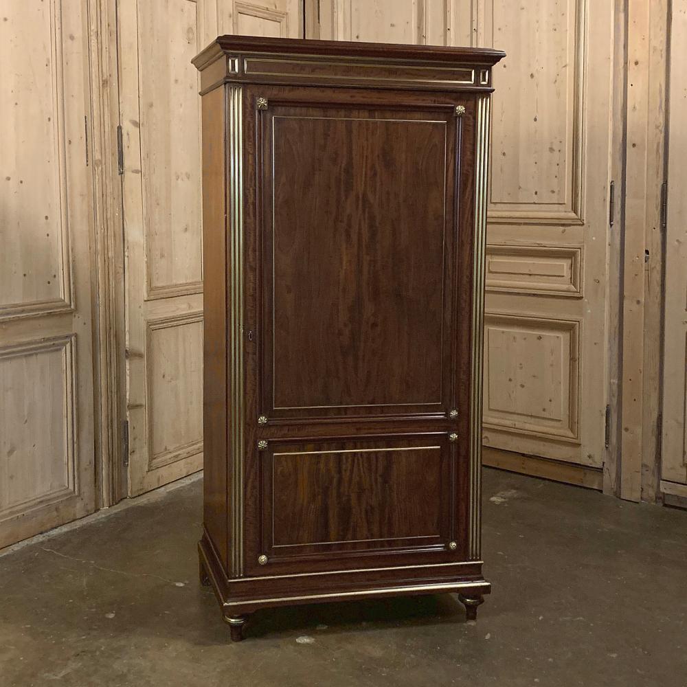 19th century French Louis XVI bonnetiere is a rare example of the formal iteration of the more typical provincial bonnetiere. In this piece, a tailored classical architecture has been employed, with exquisite imported mahogany accented with gold