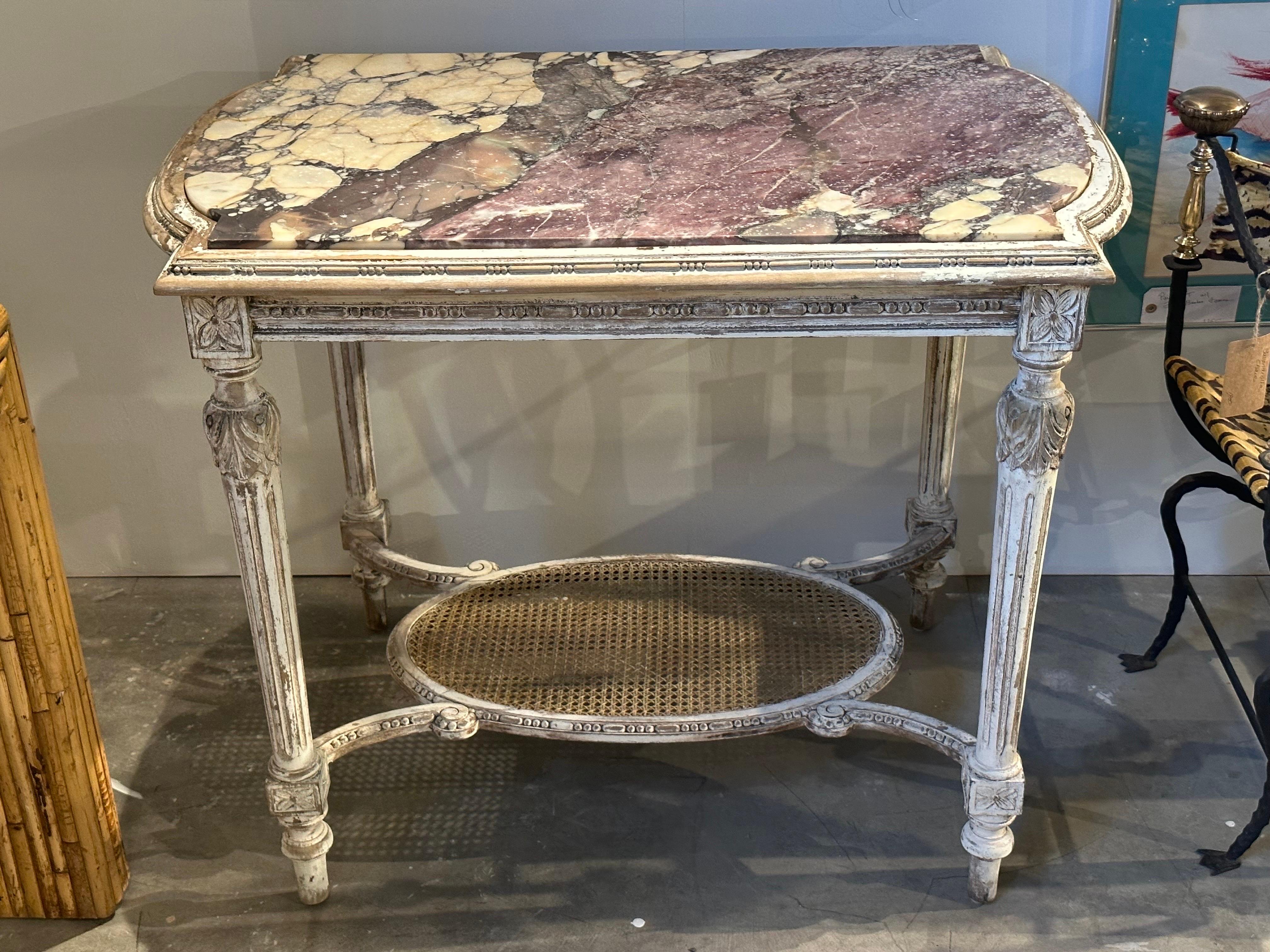 Late 19th/ early 20th century French Louis XVI Center Table or Console with beautiful veiny purple toned marble top. Wooden structure with stressed paint texture.