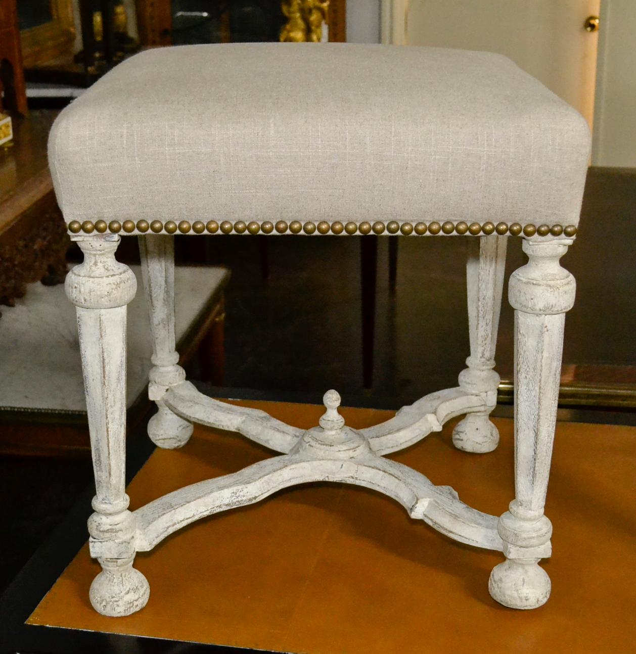 Wonderful pair of 19th century continental carved and painted benches with recent linen upholstery.