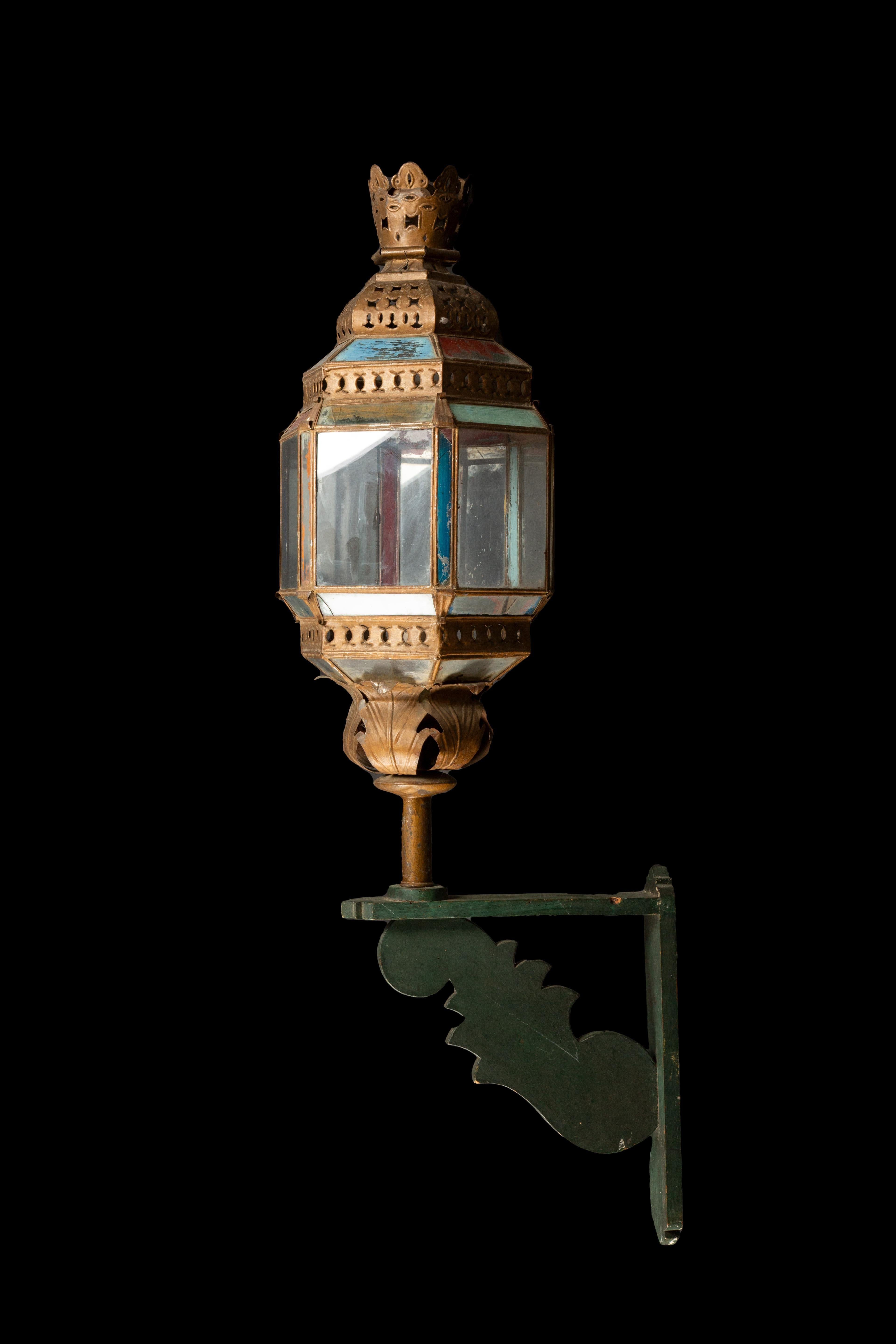 Exquisite pair of grand 19th-century Venetian lanterns, gracefully adorned with intricate craftsmanship and suspended upon meticulously crafted custom wood brackets. These magnificent lanterns, steeped in the rich history and artistic tradition of