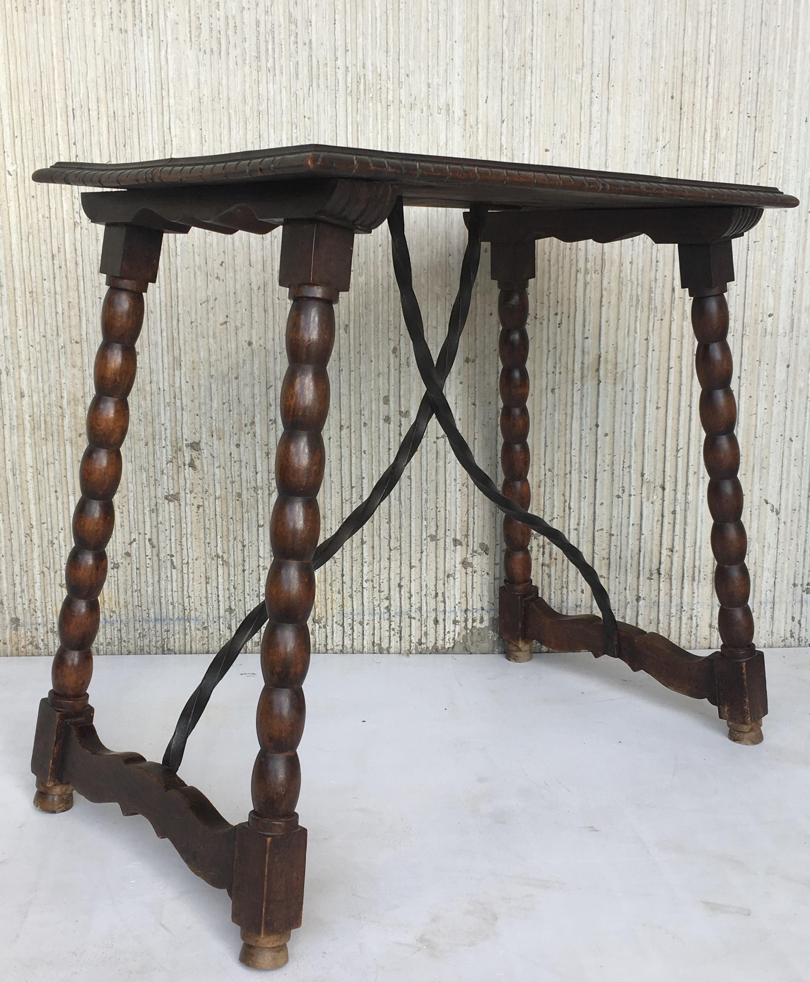 19th Century Spanish Baroque ebonized side table with iron stretcher and carved top in walnut.